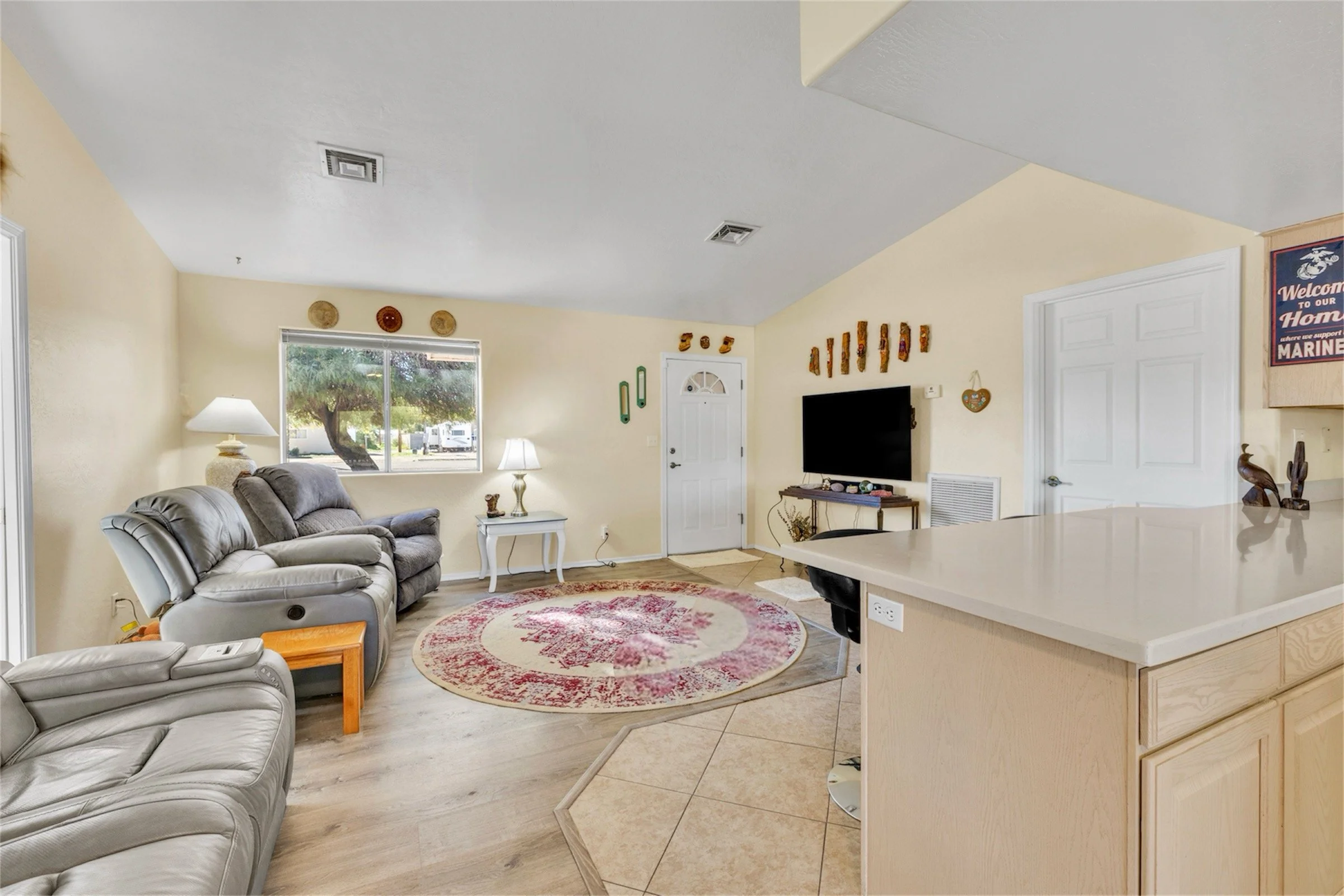 This bright living room in Queen Valley, AZ showcases comfortable seating and tasteful decor, captured perfectly with professional real estate photography for a welcoming home environment.