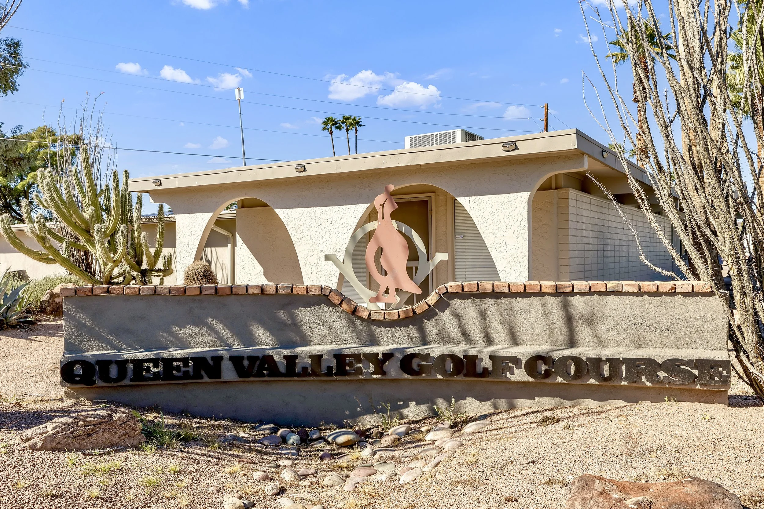This photo features the Queen Valley Golf Course entrance in Queen Valley, AZ, showcasing clear skies and desert landscaping, perfect for real estate photography focused on local amenities.