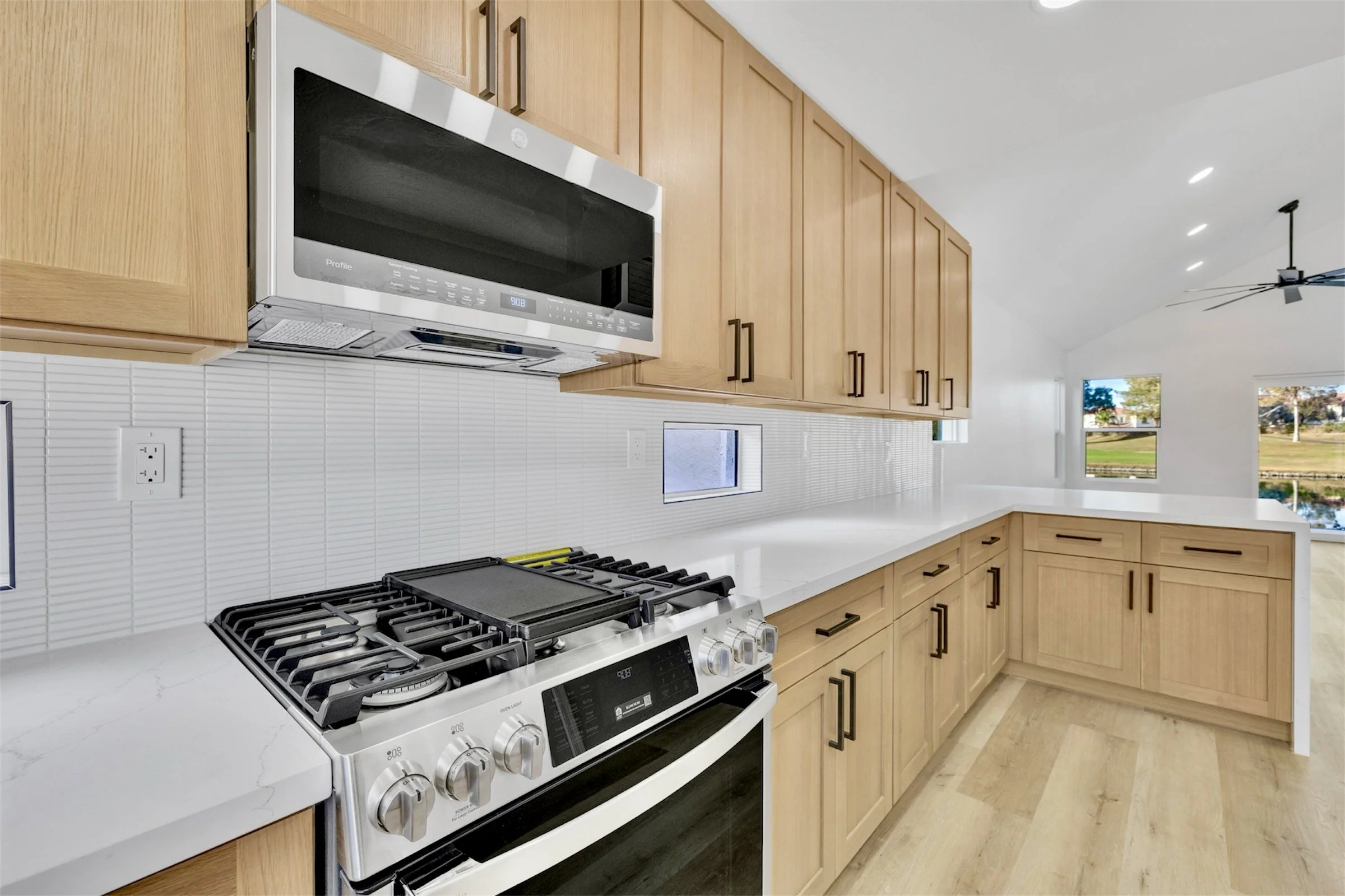 This modern kitchen in Chandler, AZ features sleek cabinetry and stainless steel appliances, perfectly captured through expert real estate photography for an appealing home listing.