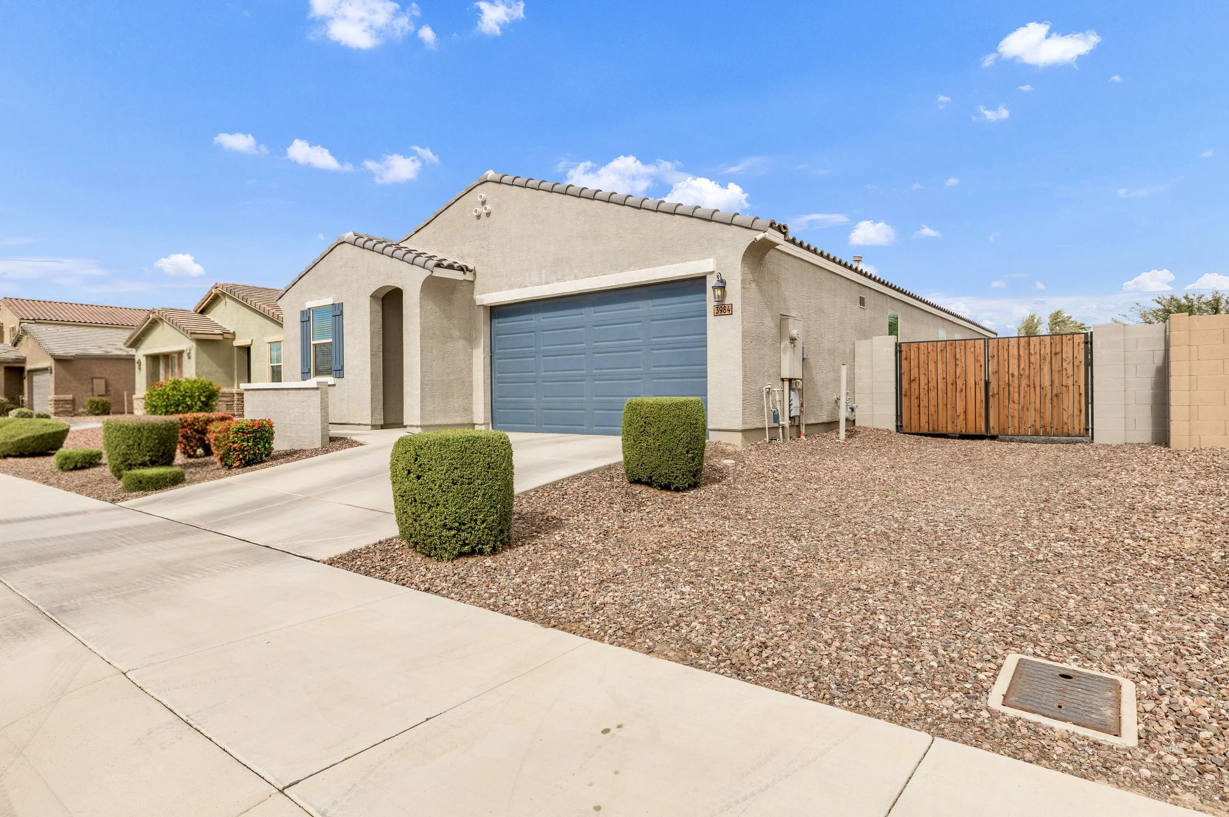 Beautiful single-story home with a two-car garage and desert landscaping featured in real estate photography in San Tan Valley, AZ.