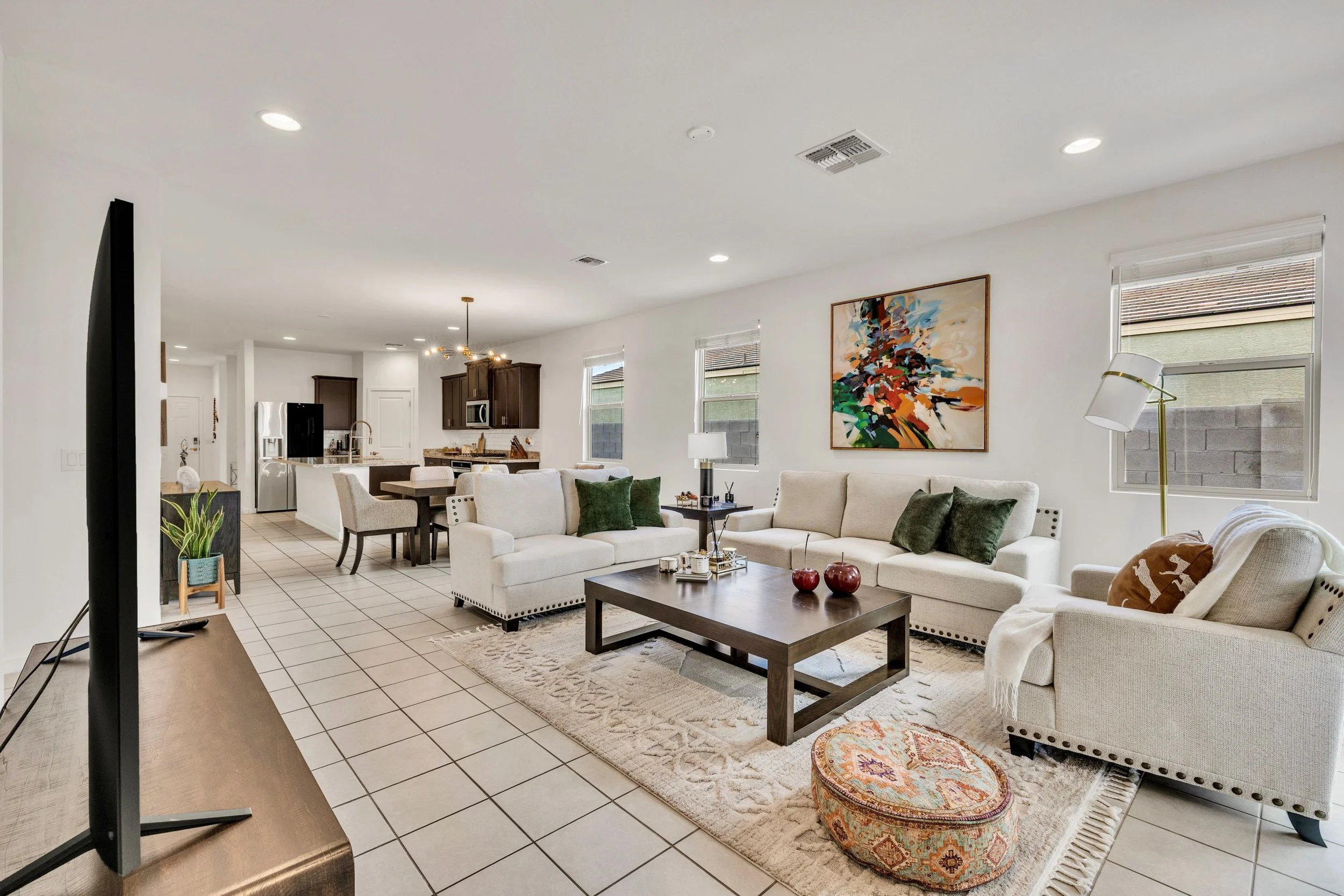 This bright open living room and dining area in San Tan Valley, AZ features modern decor and ample natural light, captured perfectly by expert real estate photography.