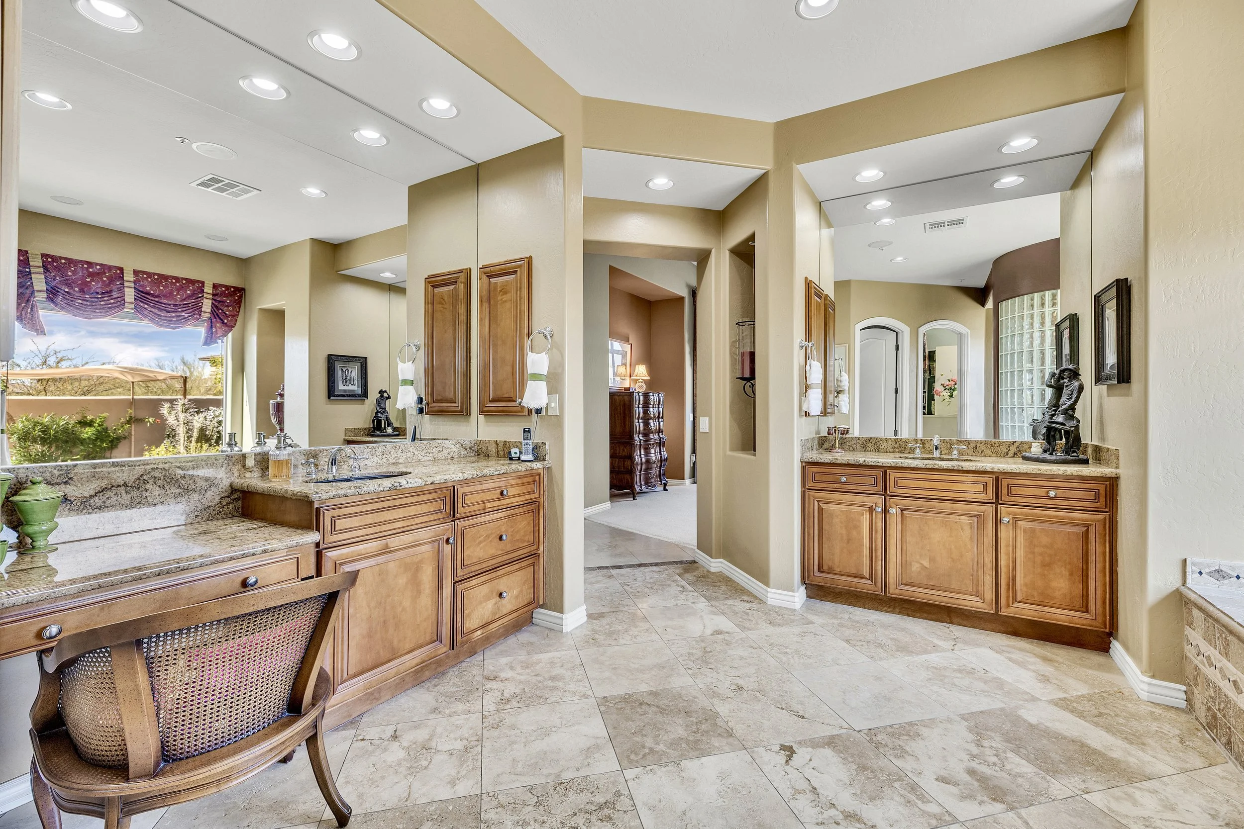 This luxurious bathroom in Scottsdale, AZ features elegant granite countertops and spacious vanities, captured beautifully through expert real estate photography.