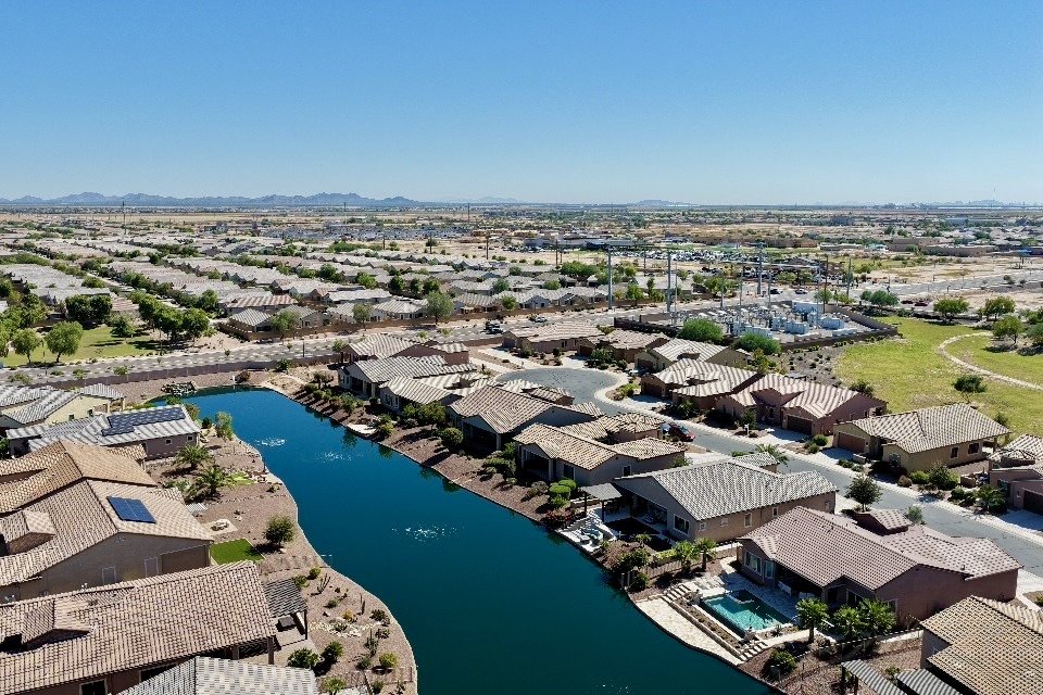 Daytime drone view of an Arizona lakeside residential community.