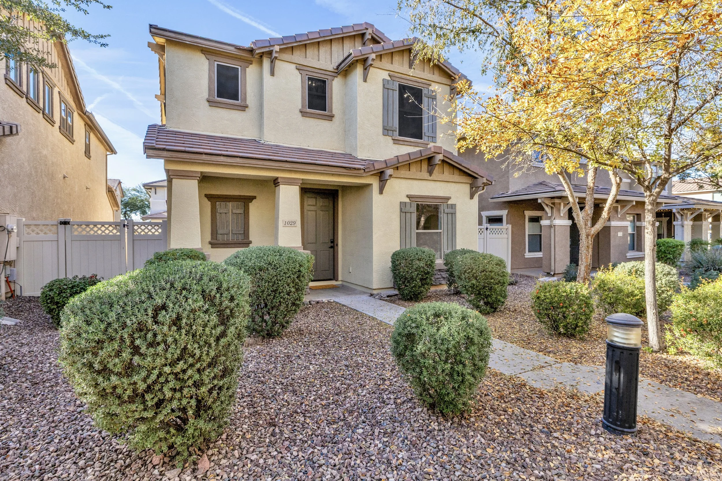 This charming two-story home in Gilbert, AZ, features a well-maintained front yard and inviting entrance, captured expertly with real estate photography to showcase its curb appeal on S Cheshire Ln.