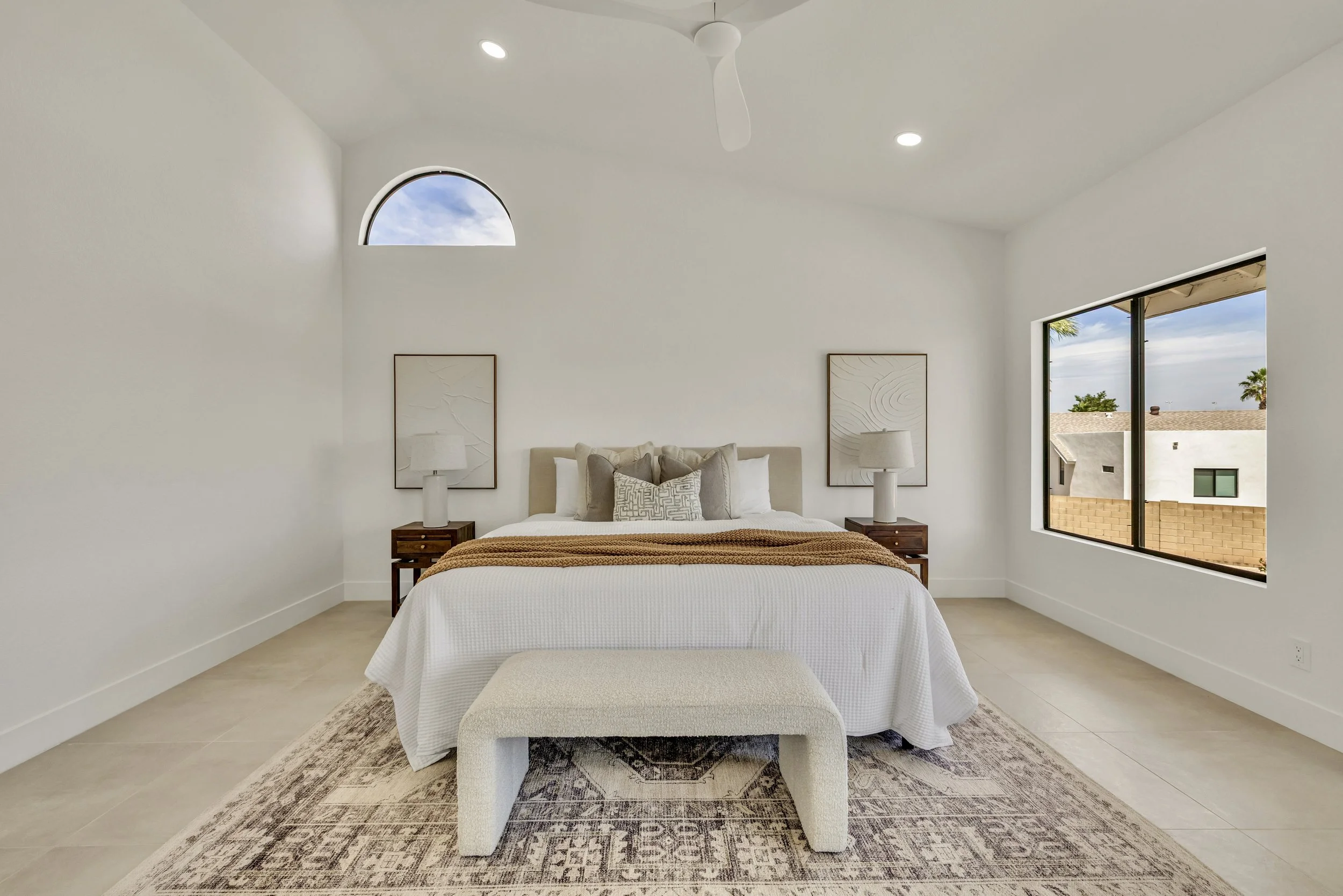 This bright bedroom in Scottsdale, AZ features modern decor and plenty of natural light, captured with professional real estate photography to highlight its spacious and welcoming ambiance.