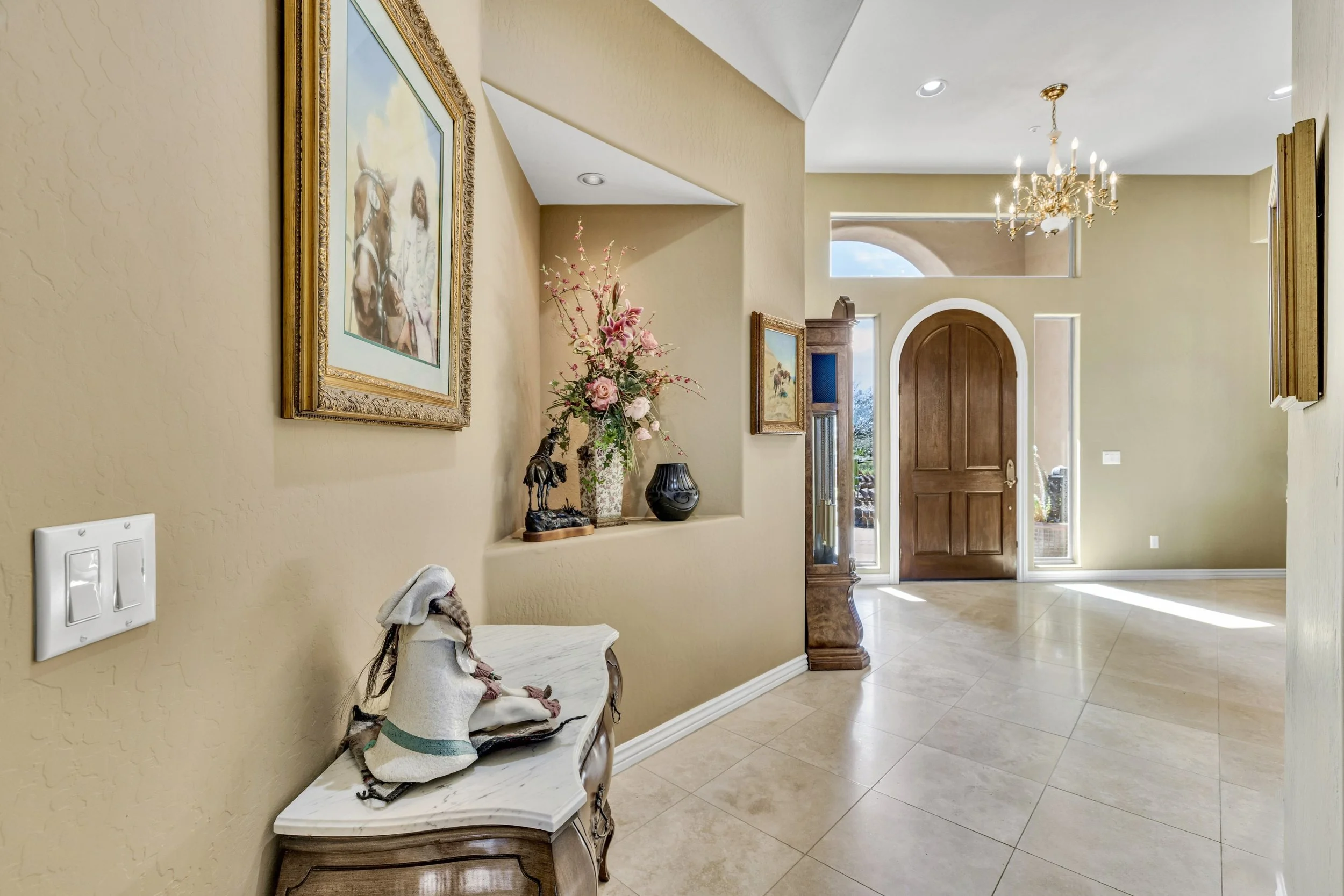 Bright and elegant entryway with tiled floors and decorative accents in a Scottsdale, AZ home showcased through professional real estate photography.