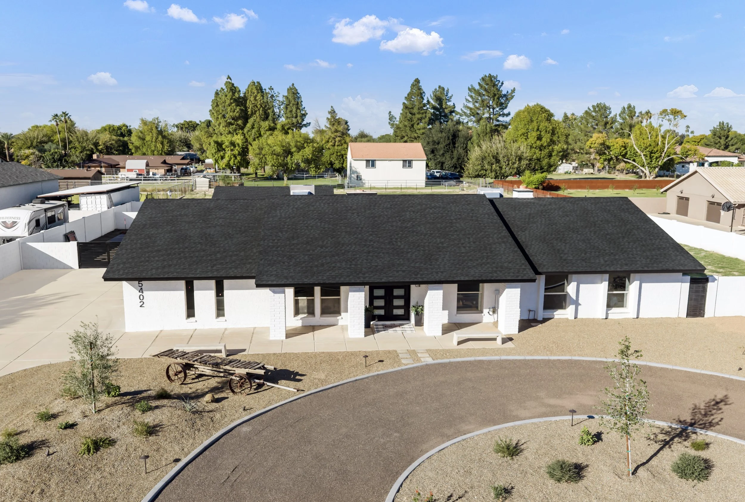 Front aerial view of a ranch-style home in Arizona with circular driveway.
