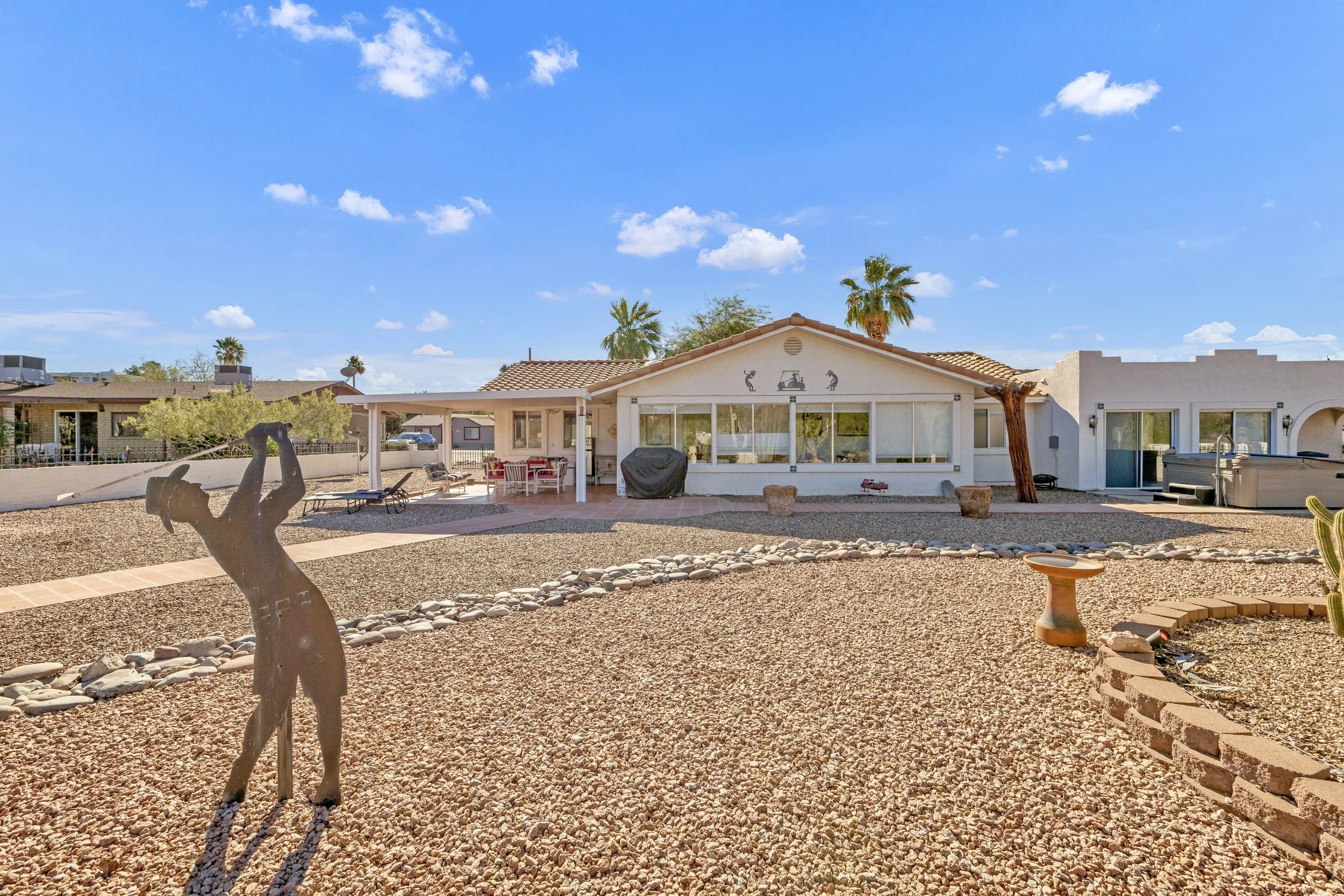 Stunning desert landscaping enhances this home in Queen Valley, AZ, captured with expert real estate photography showcasing outdoor features and backyard space.