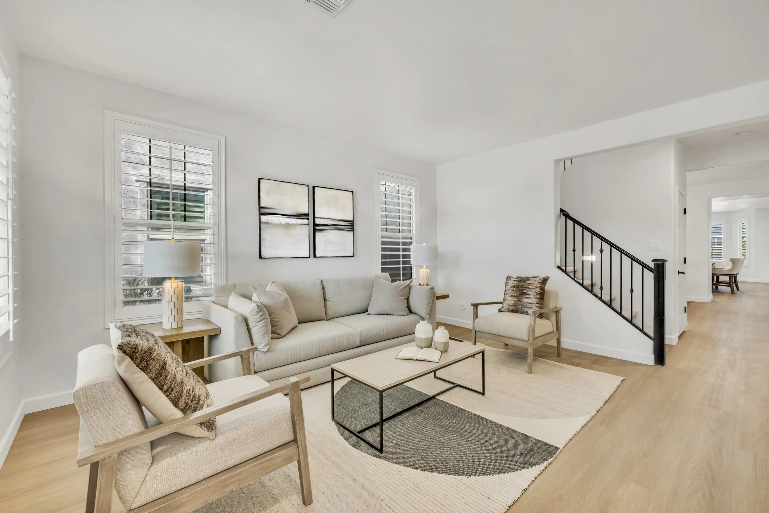 This modern living room features neutral tones and stylish furnishings, captured in real estate photography in Gilbert, AZ.