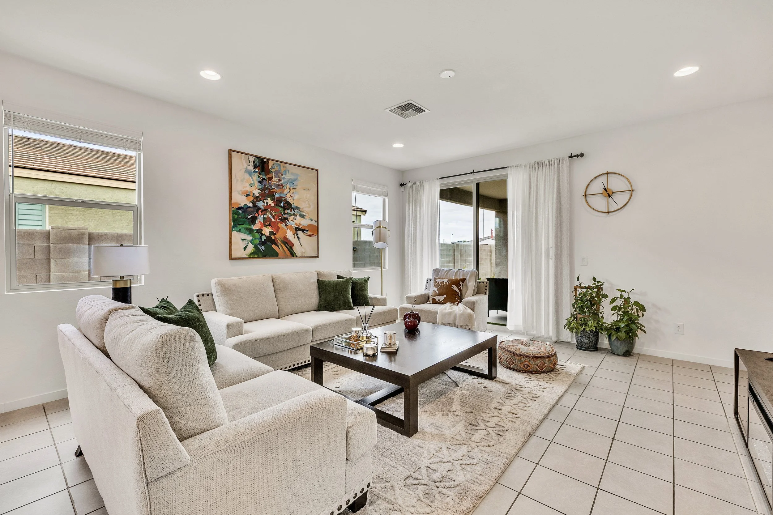 This bright modern living room features comfortable seating and ample natural light, showcased in professional real estate photography in San Tan Valley, AZ.