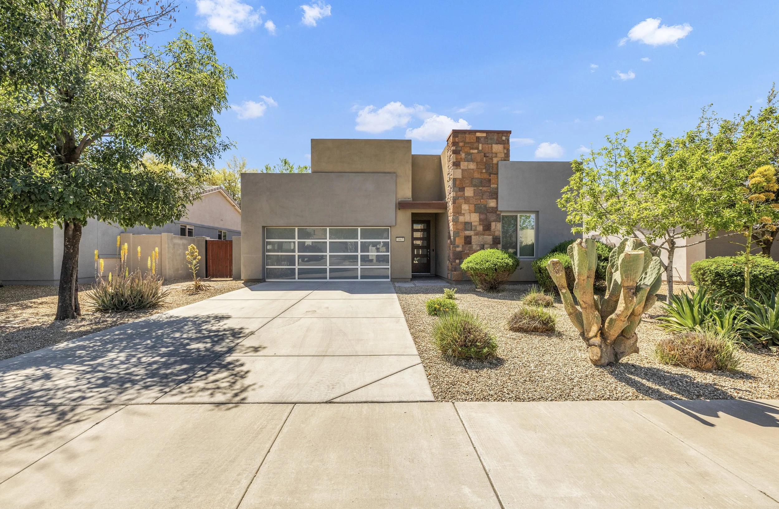 This modern home in Gilbert, AZ features a clean exterior design and desert landscaping, captured with professional real estate photography to showcase its curb appeal on E Lafayette Ave.