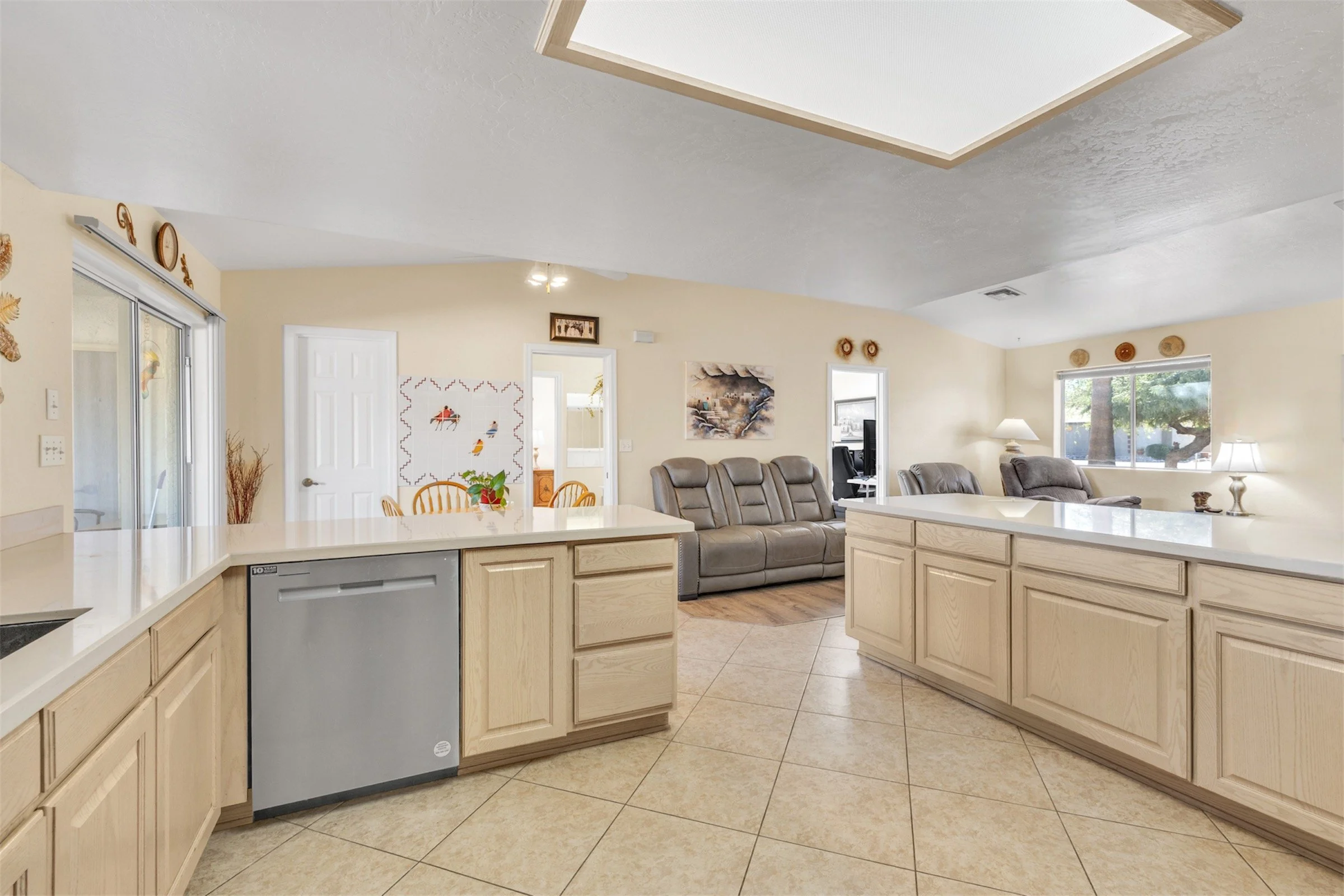 Bright open kitchen and living room with modern appliances and comfortable seating showcased in this Queen Valley, AZ home through professional real estate photography.