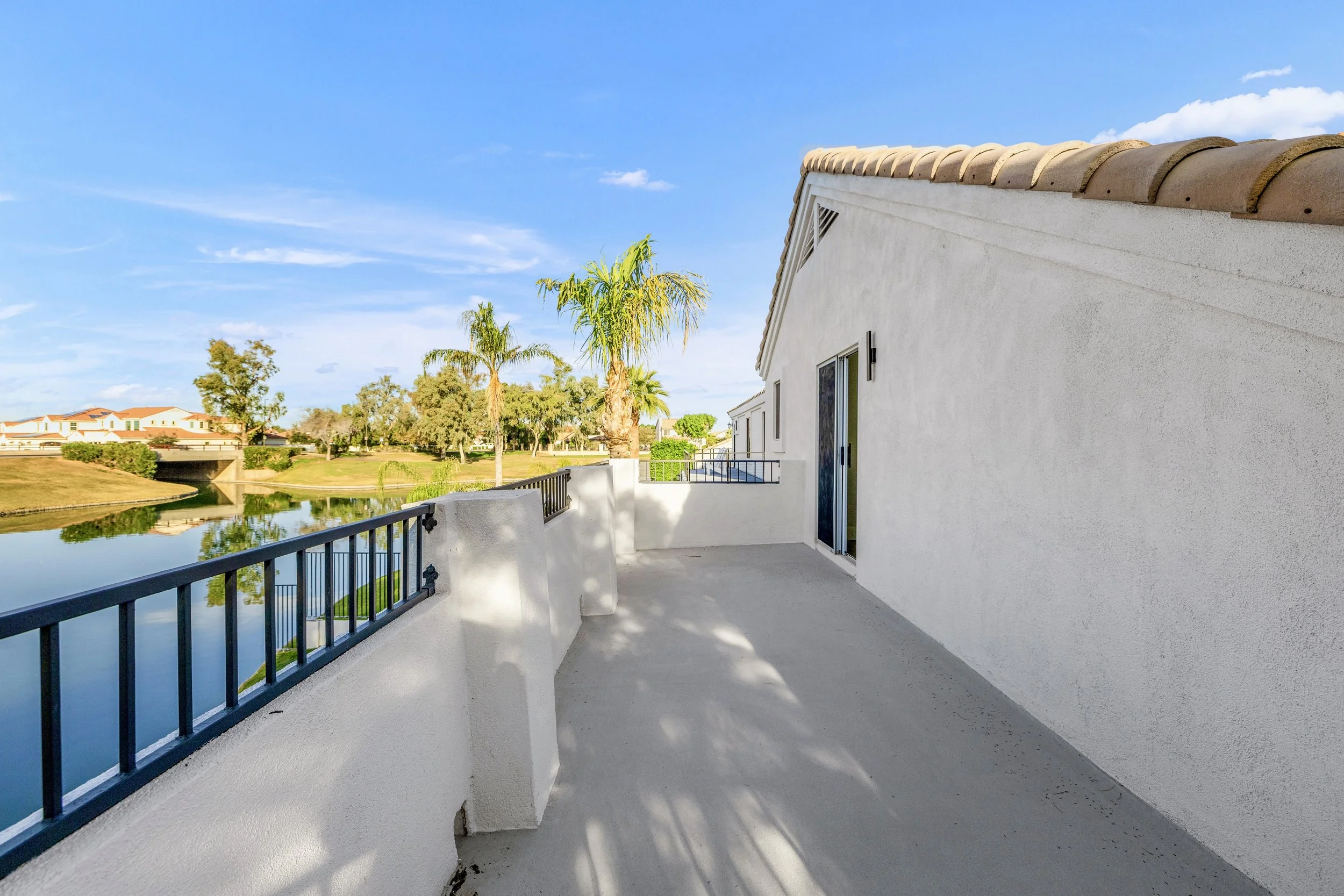 This spacious balcony offers stunning water views in Chandler, AZ, exemplifying high-quality real estate photography for waterfront properties.