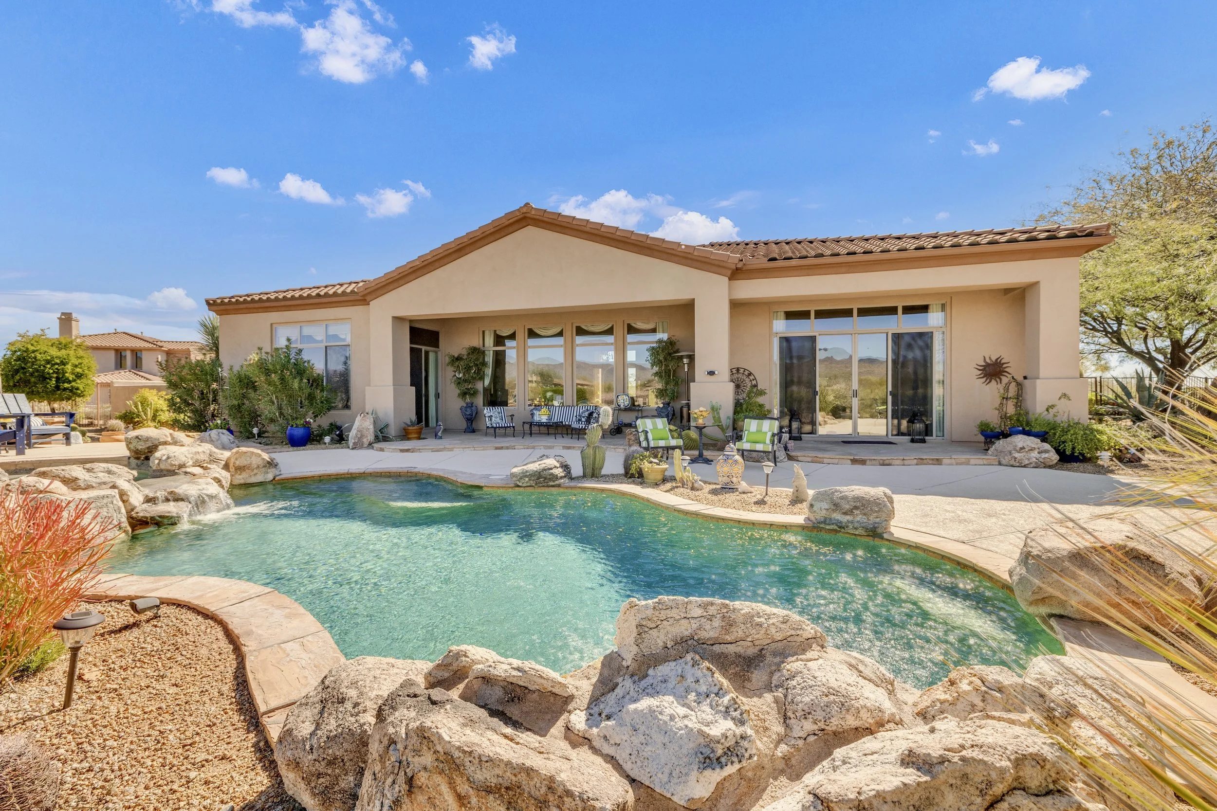 This Scottsdale, AZ home features a beautiful backyard with a rock-edged pool and spacious patio captured with expert real estate photography.