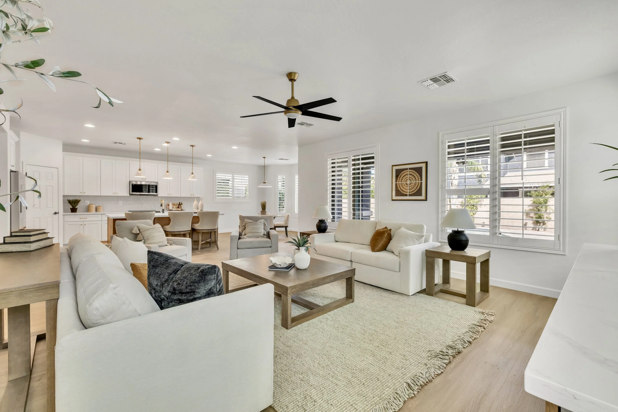 This bright and modern open living room and kitchen showcase stylish design in Gilbert, AZ, captured with expert real estate photography in Morrison Ranch neighborhood.