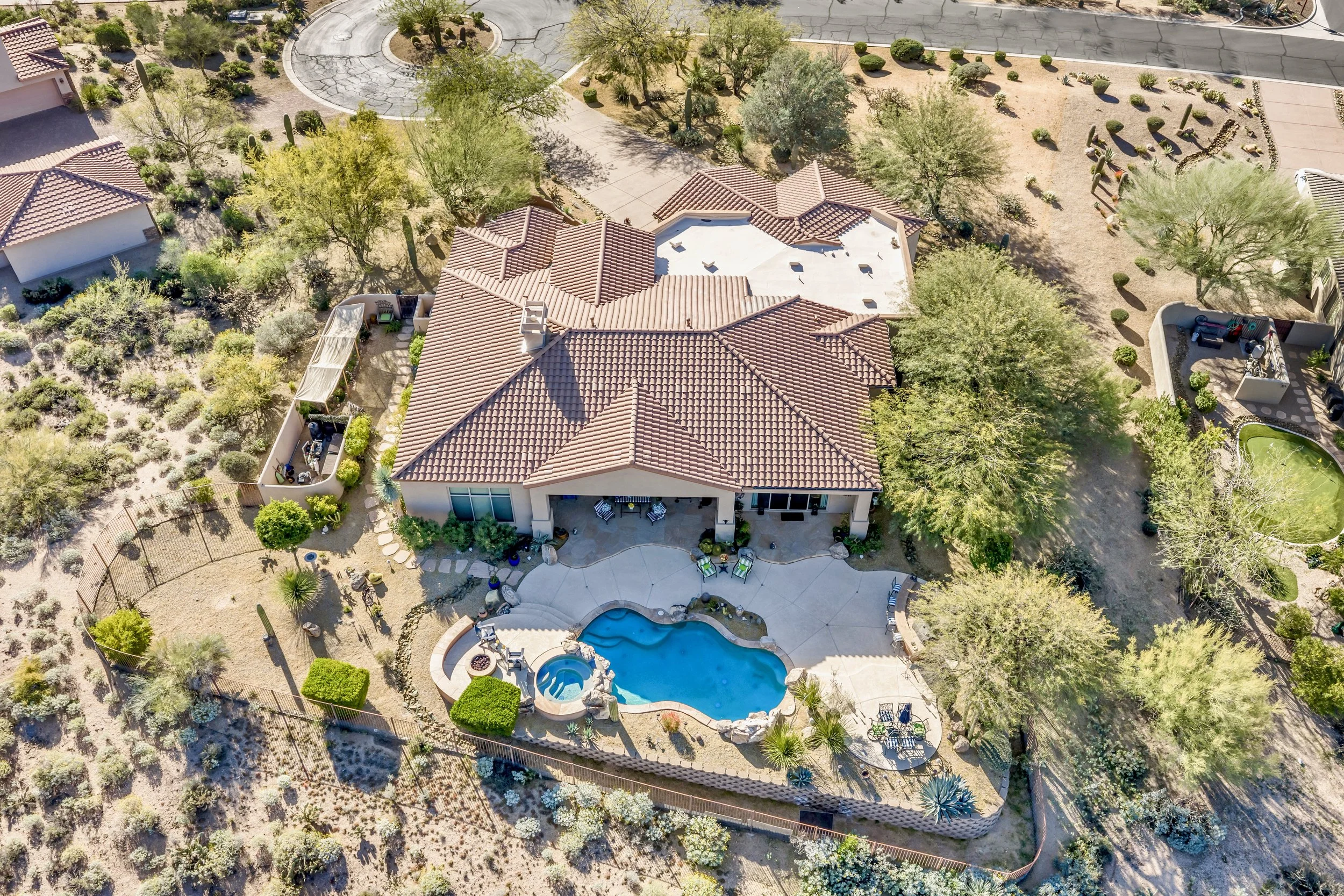 Aerial real estate photography showcasing a Scottsdale, AZ home with a pool and desert landscape, highlighting outdoor living space and natural surroundings.