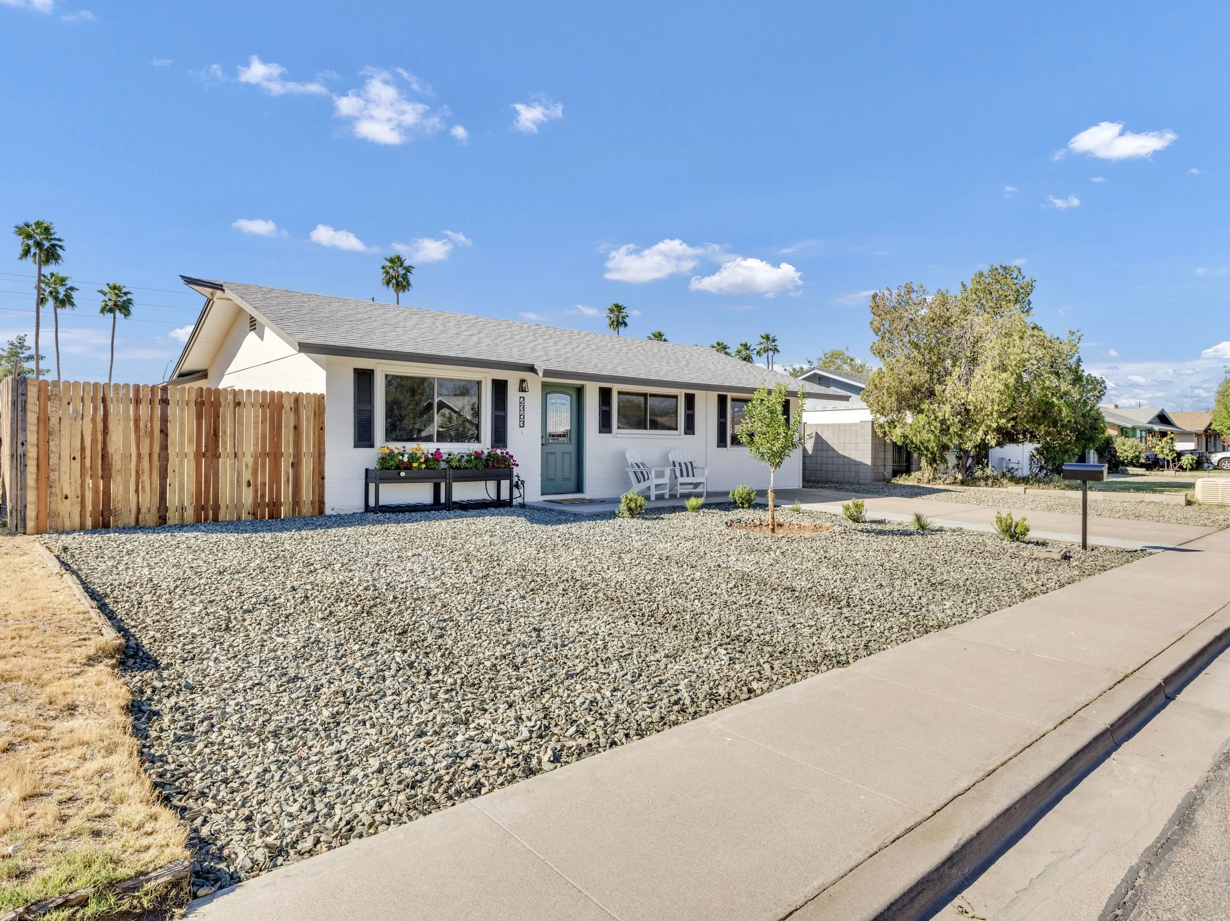 This single-story home in Mesa, AZ features a clean exterior with a low-maintenance front yard, captured in high-quality real estate photography perfect for property listings.