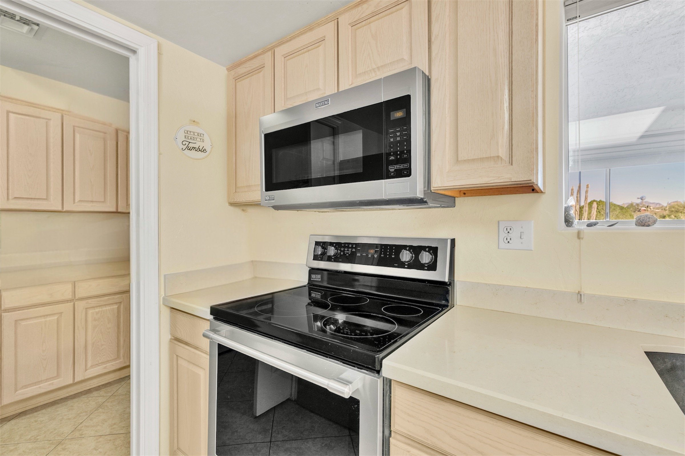This kitchen in Queen Valley, AZ features modern appliances and ample cabinetry, showcased with professional real estate photography to highlight its clean and functional design.