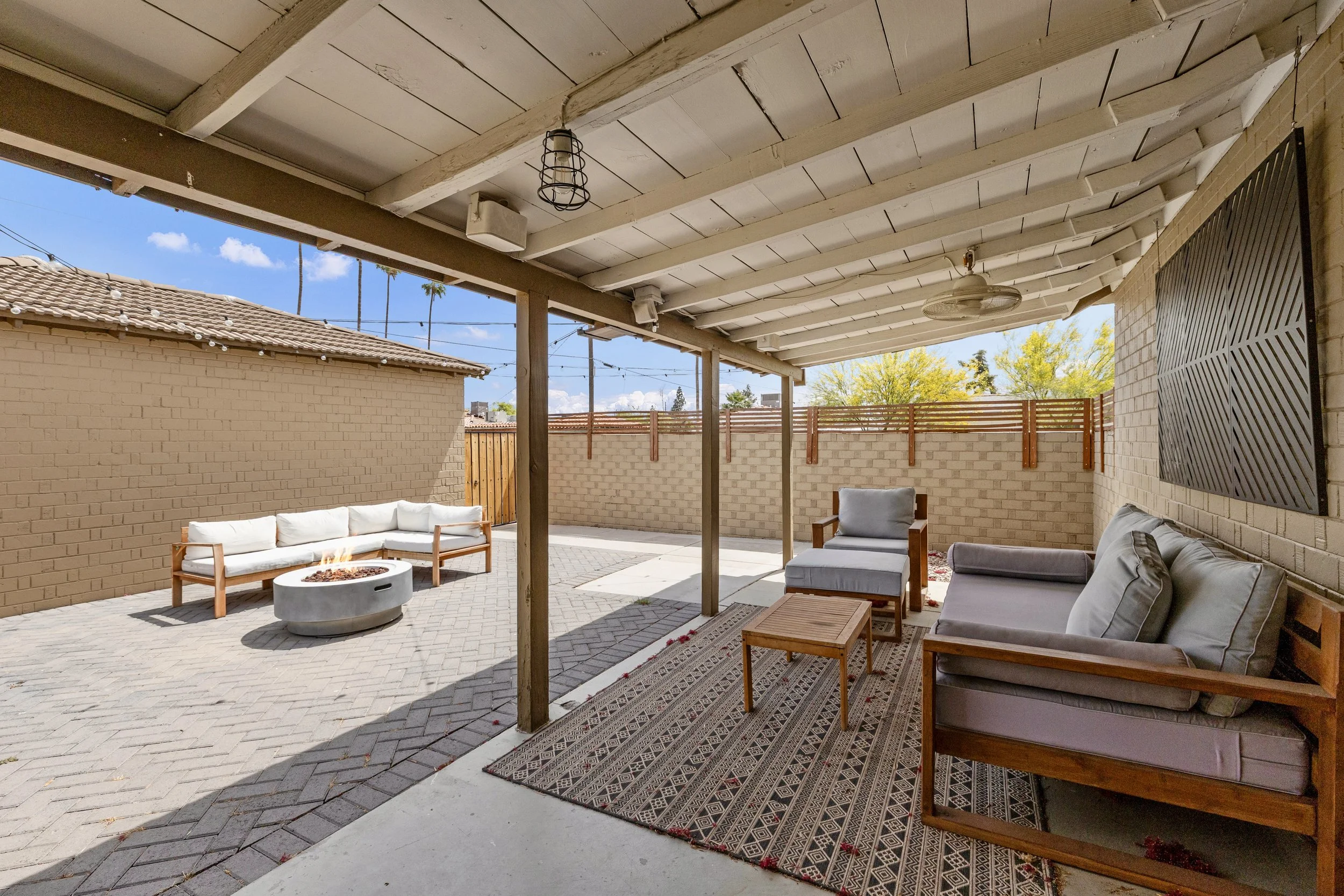 This Phoenix, AZ patio features comfortable outdoor seating and a firepit, perfectly captured in this real estate photography for a relaxing backyard space.