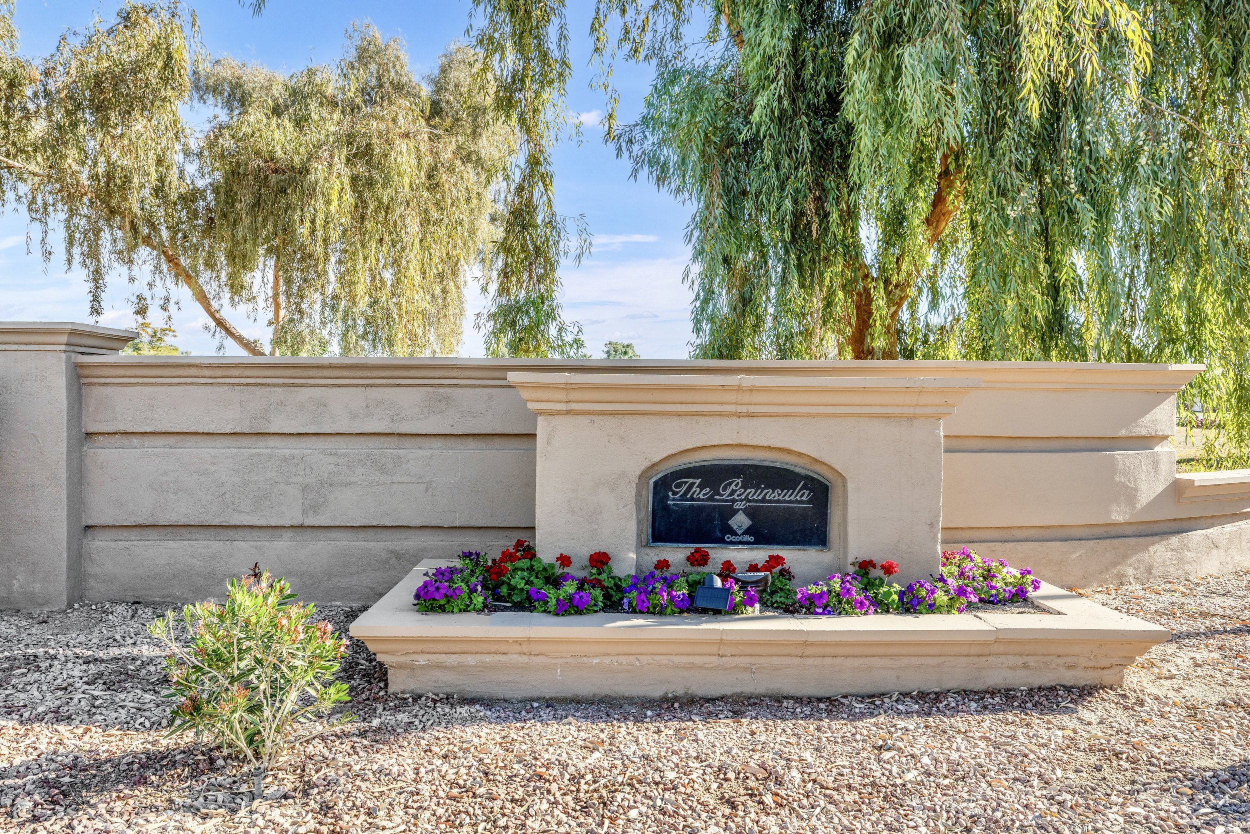 Beautiful entrance sign at W Peninsula Cir, Chandler, AZ captured with professional real estate photography showcasing community charm and landscaping.