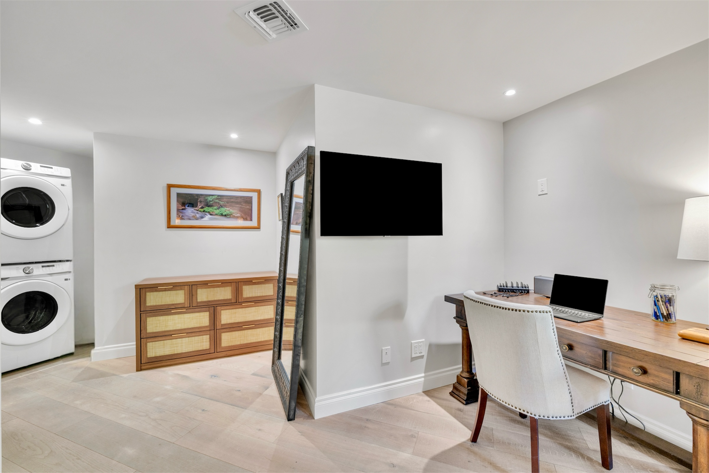 This modern interior features a home office next to a laundry room in Paradise Valley, AZ, captured with professional real estate photography showcasing organized and stylish living spaces.