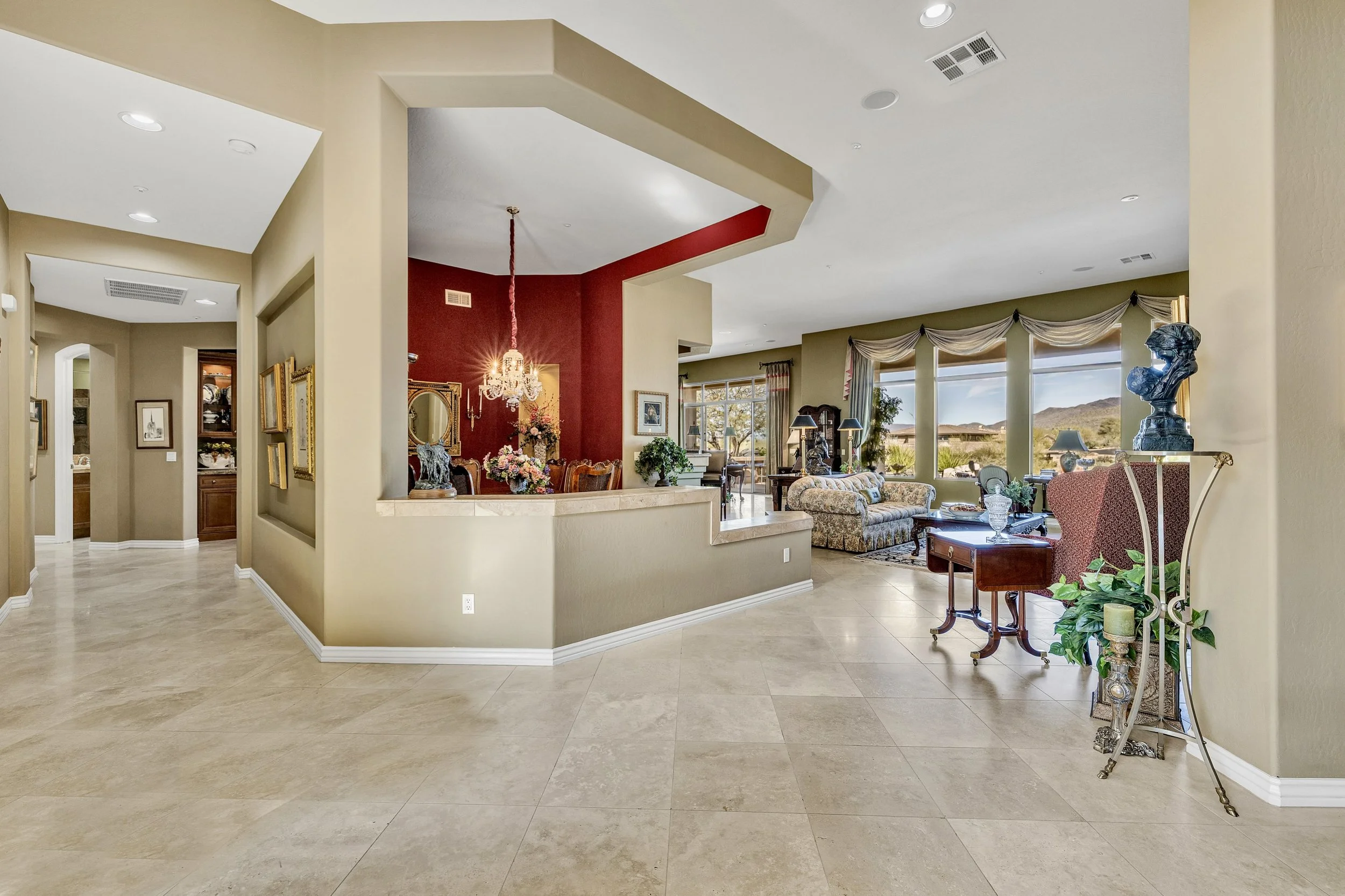 Bright and spacious living room and dining area with elegant decor and large windows in Scottsdale, AZ, captured with professional real estate photography.