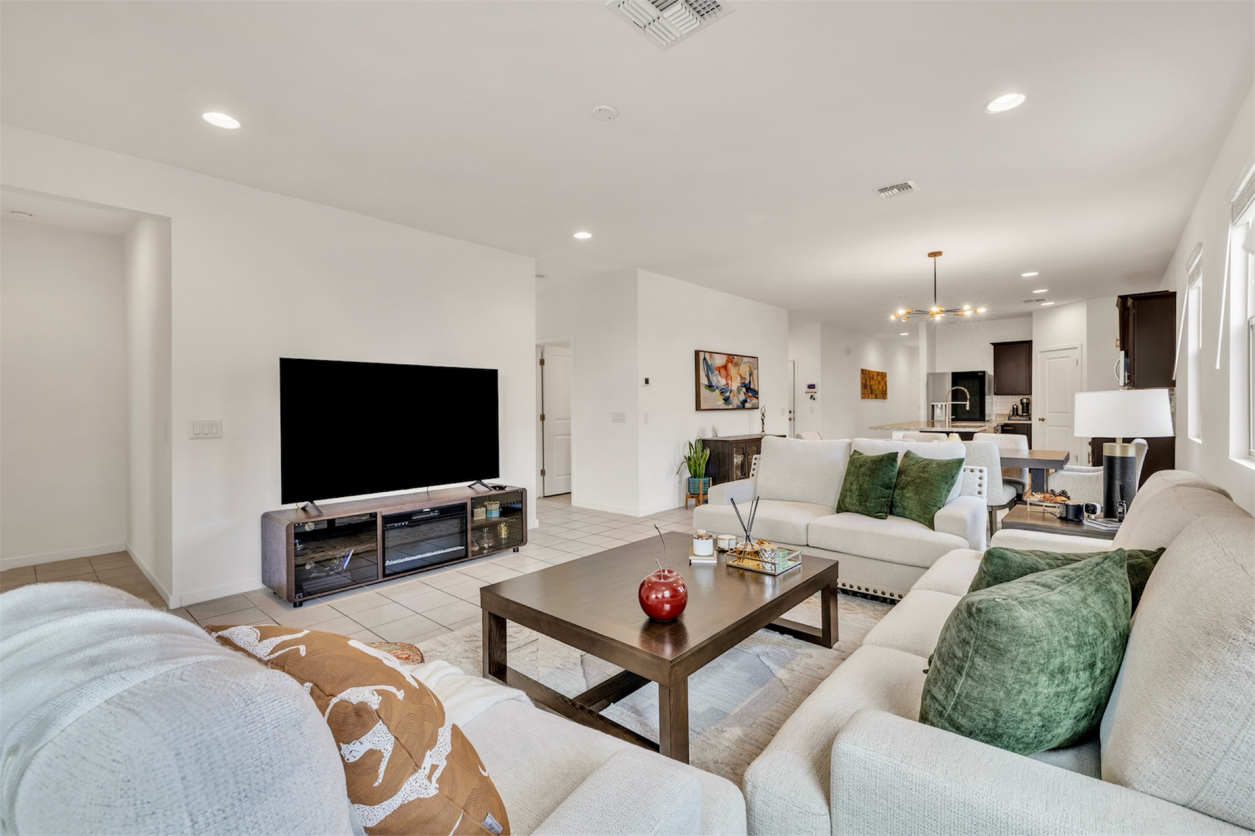 Spacious open-concept living room and kitchen in a San Tan Valley, AZ home showcasing elegant real estate photography with modern furnishings and bright natural light.