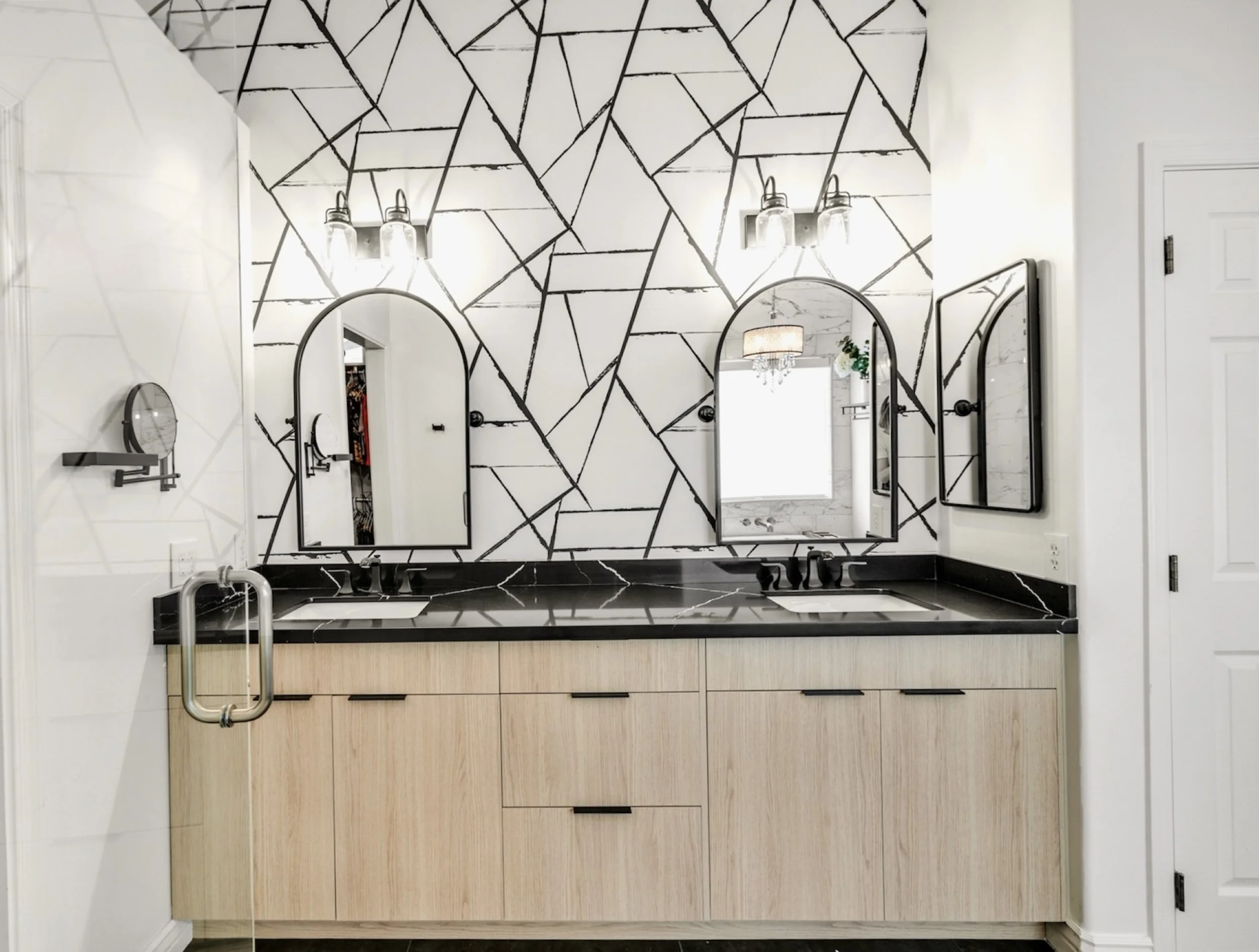 This modern bathroom in Gilbert, AZ features a double sink vanity and stylish geometric wall design, showcased through professional real estate photography.