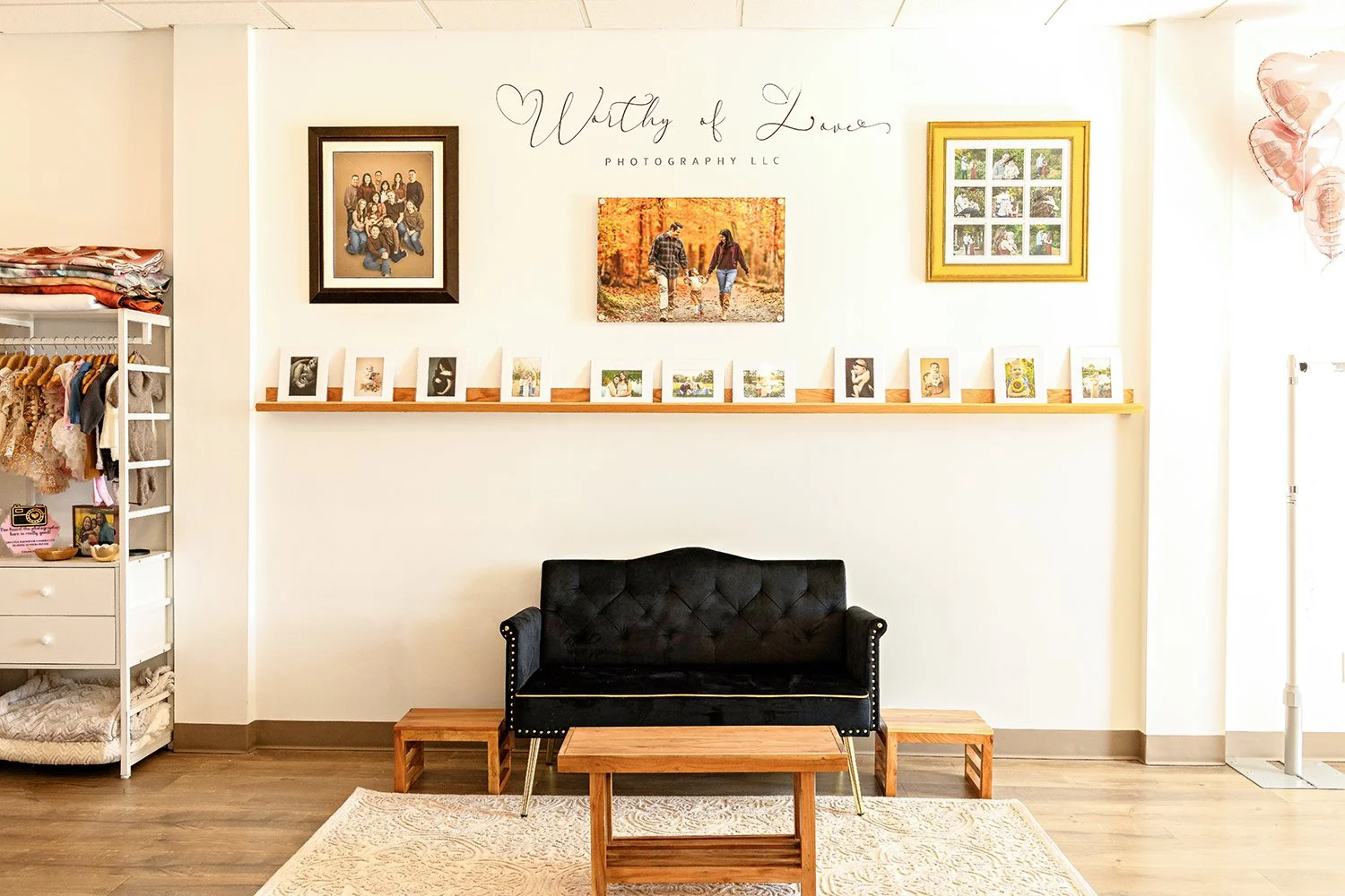 A wall is beautifully decorated with a logo and the artwork of Front Royal, VA photographer of Worthy of Love Photography in Front Royal, VA.