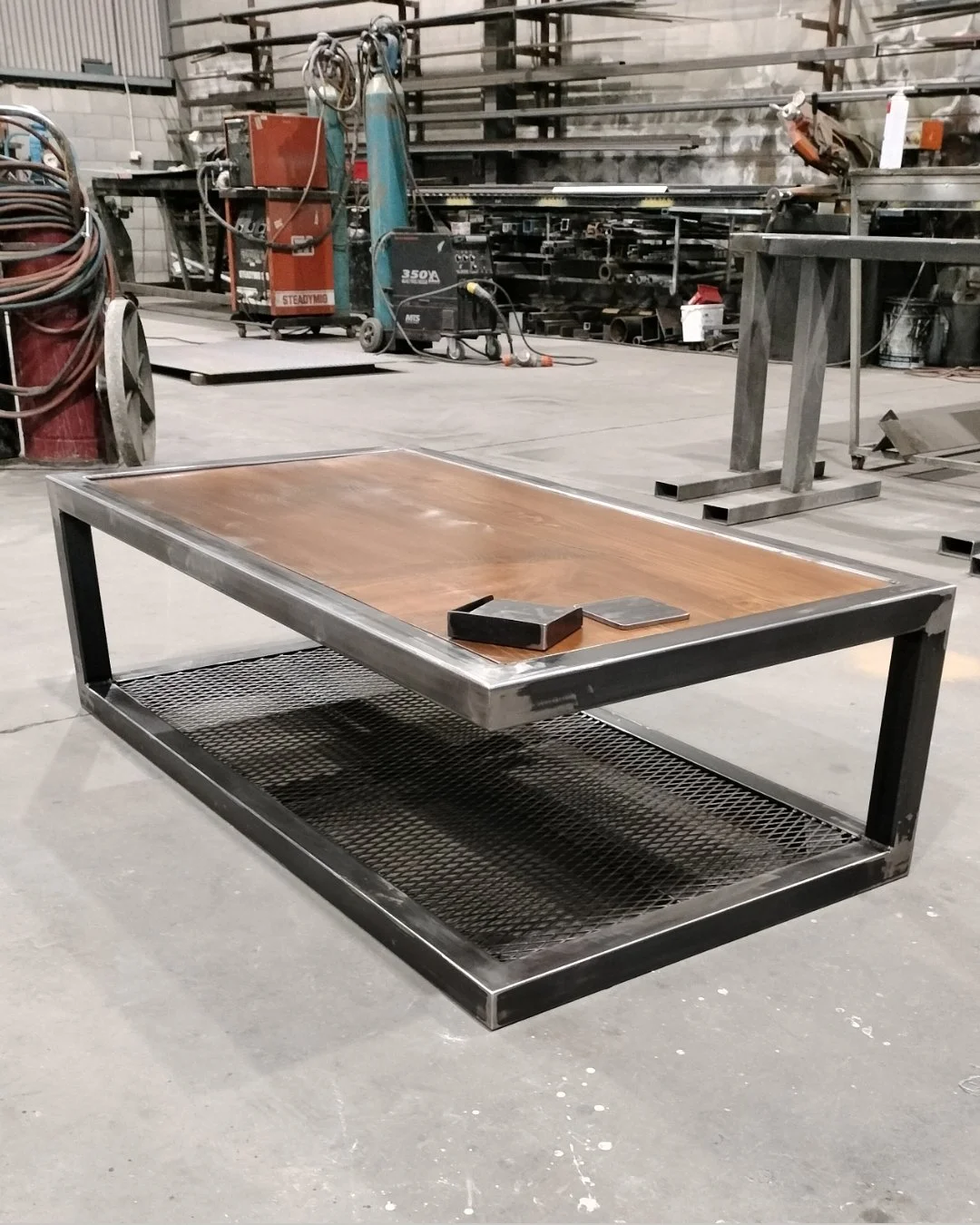 Rustic coffee table, finished in a wax coating, steel coasters to suit.