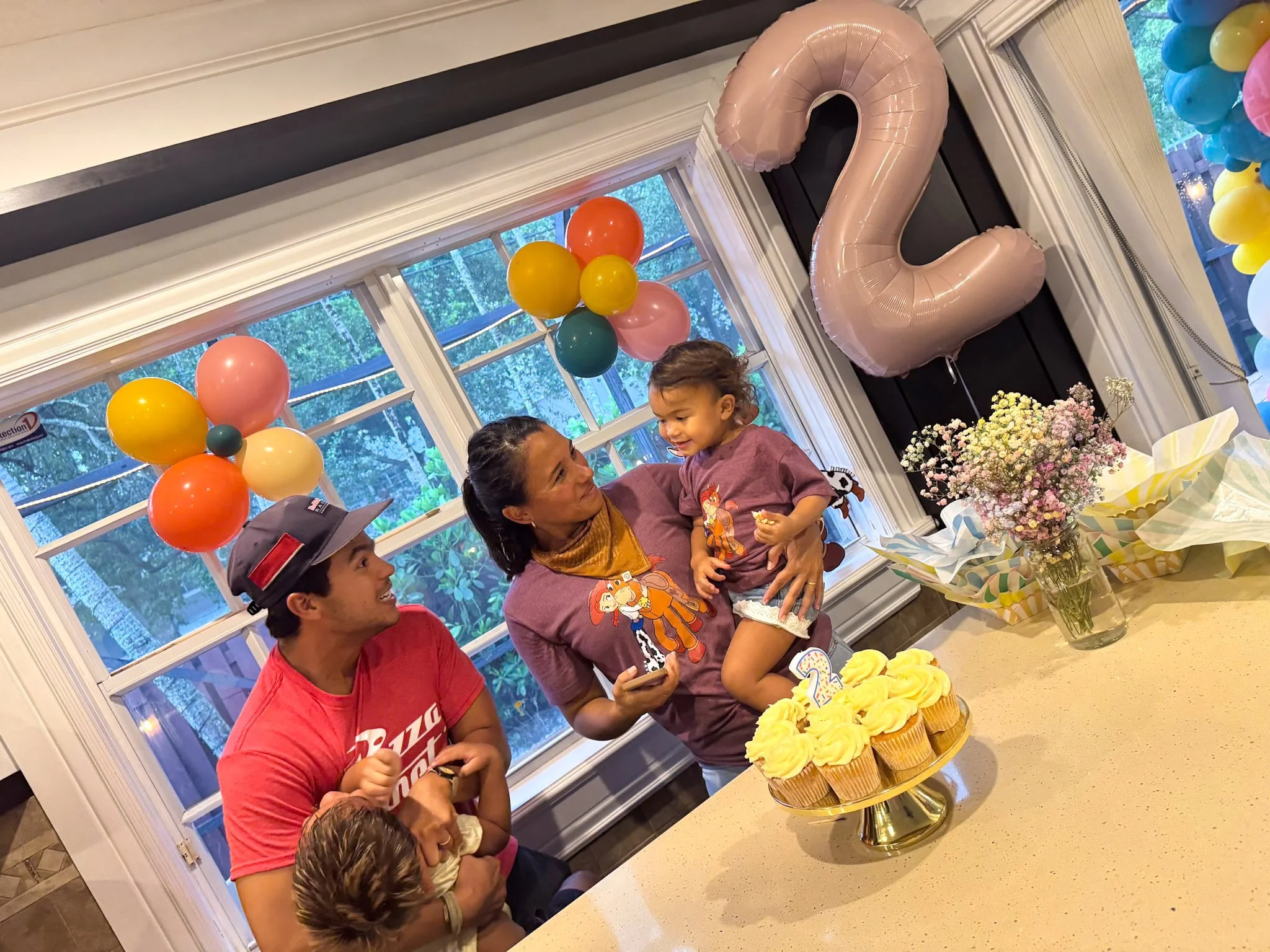 Family singing happy birthday. Girly Toy Story decoration.