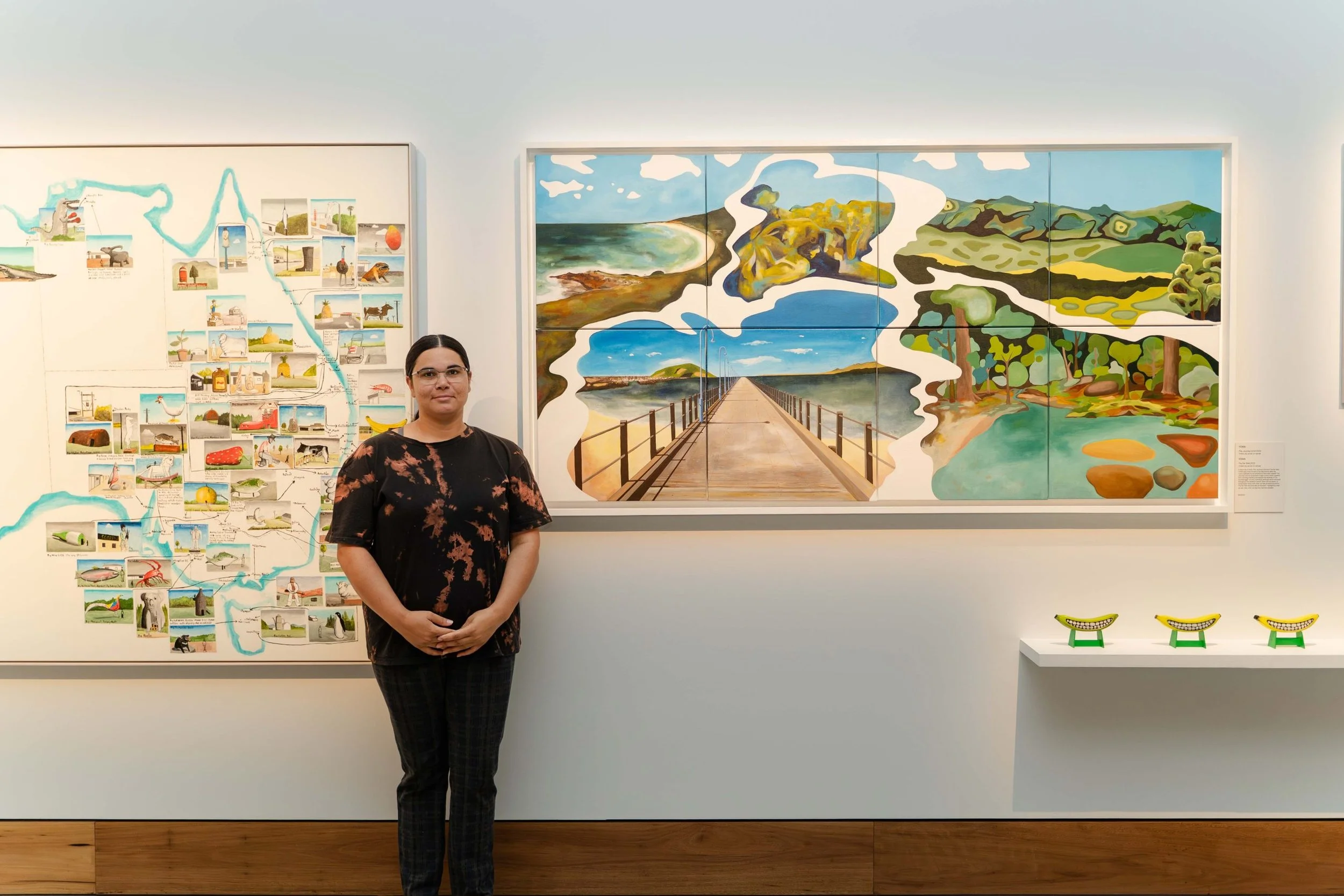 YOWA pictured with artwork ‘The Journey’s End’ and ‘The Far Side’ 2023, Timber, ply, melamine MDF with acrylic, ink and mixed media. Image credit: And the Trees Photography.