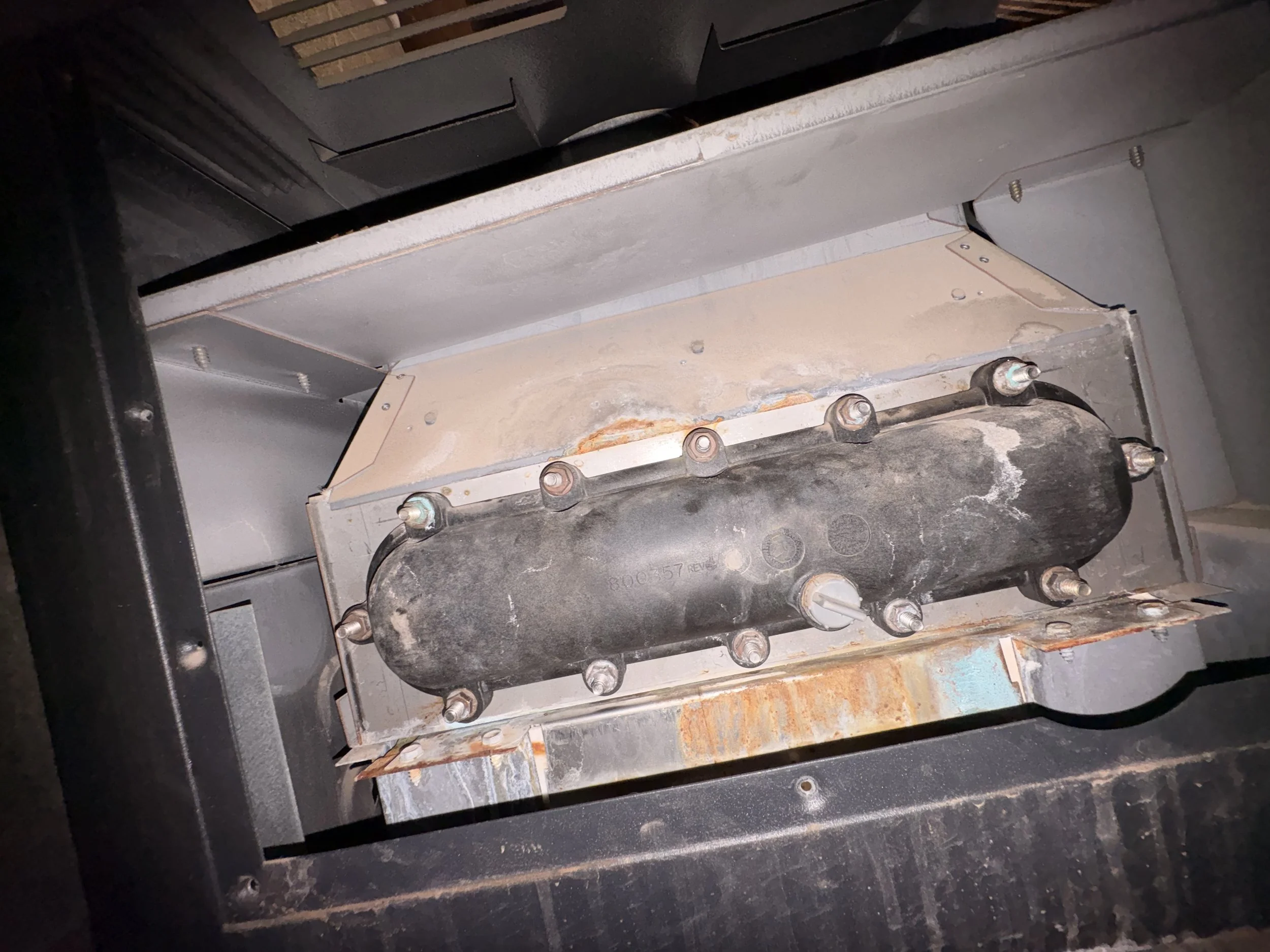 Close-up of an electrical heater element inside a heating device, showing metal components and wiring.