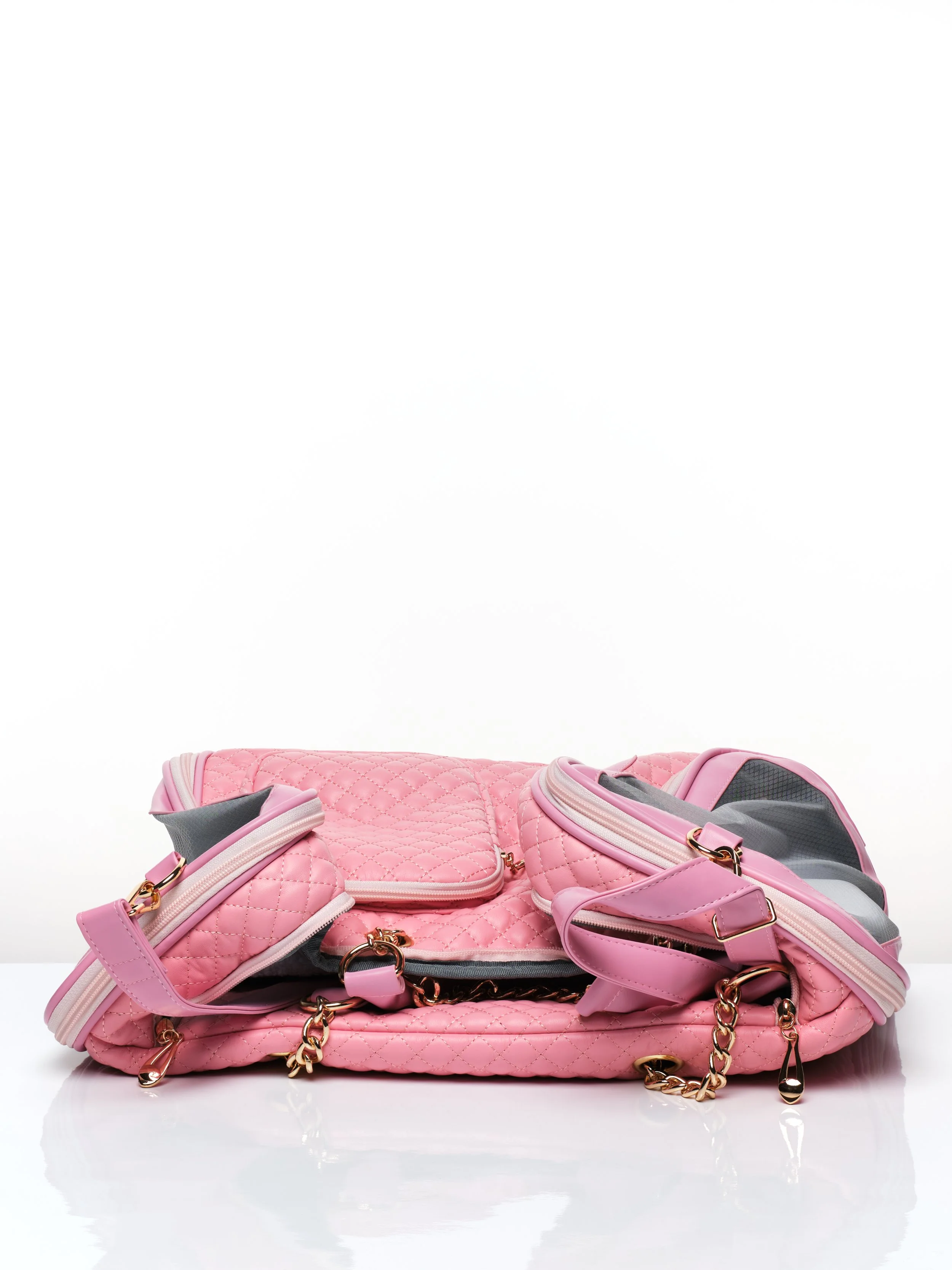 The KibbleTime Pink Ambassadeur Tote pet carrier collapsed down for easy storage.