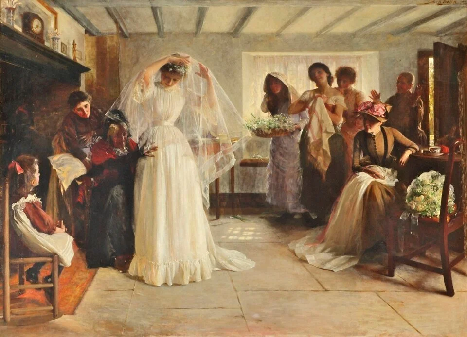 A group of women and children in a room, with one woman dressed as a bride in a white wedding gown and veil, surrounded by other women and children, some holding flowers and others seated or standing, in a vintage style painting.