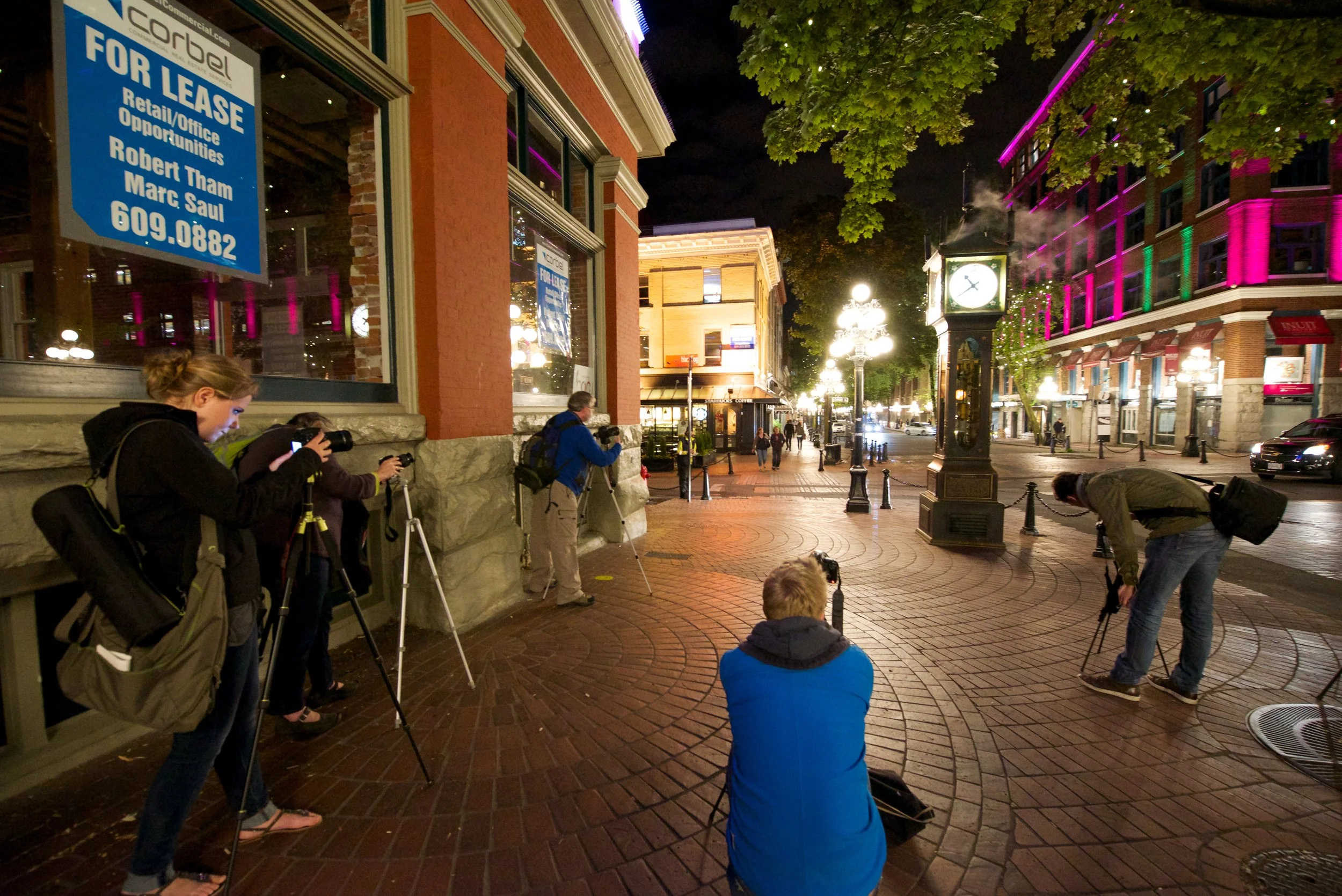 Beginner photographers with tripods shooting night scenes in Gastown, Vancouver