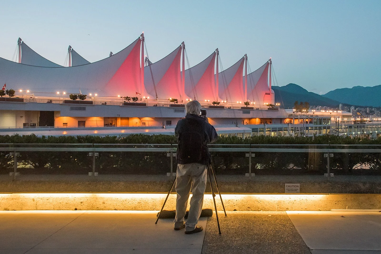 Photographer capturing Canada Place sails at night during Vancouver photography course