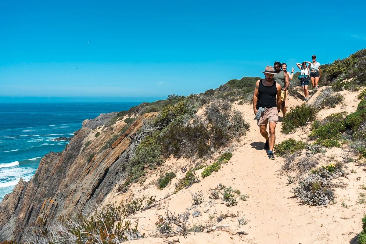 Hiking cliffside trail on retreat, movement retreat photography