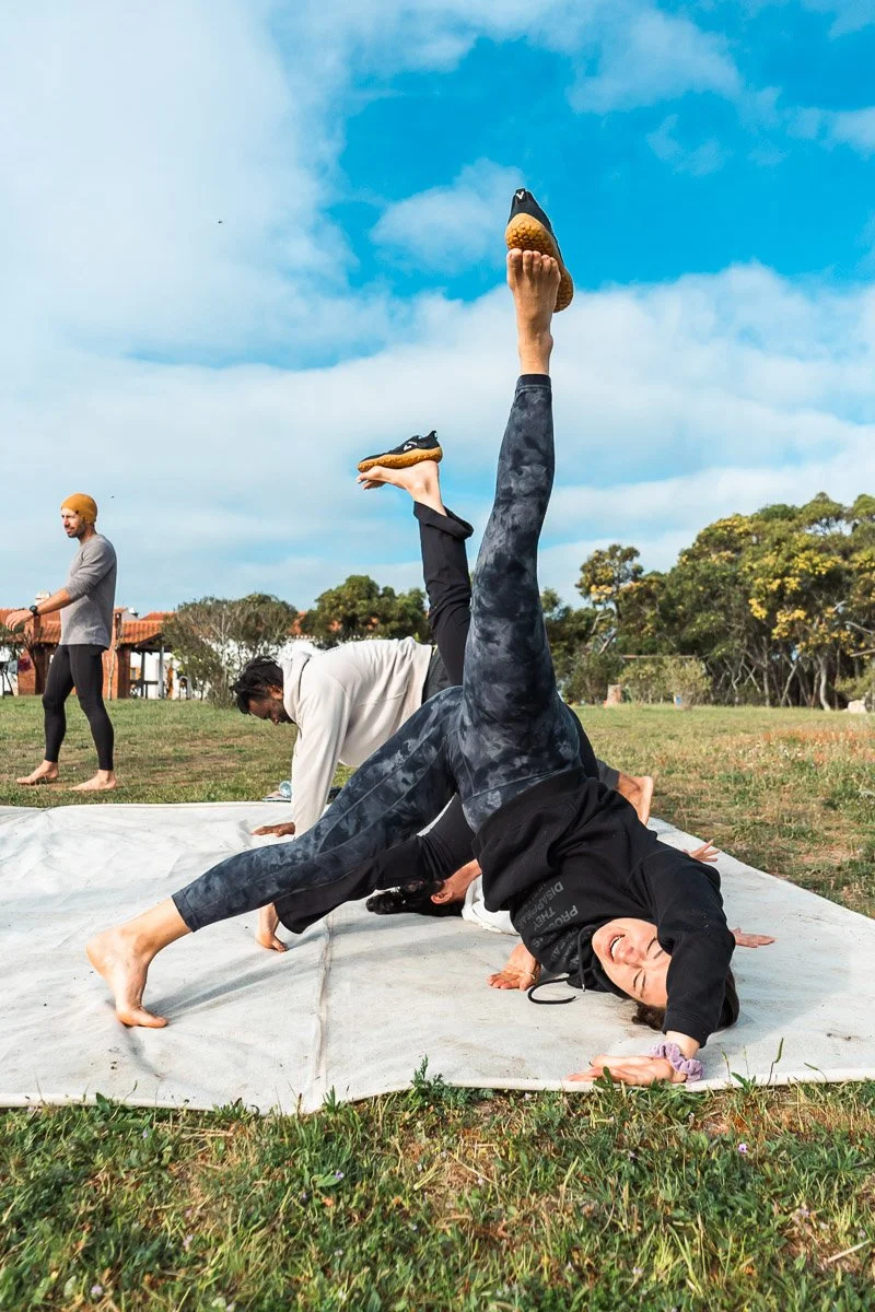 Yoga inversion outdoors at retreat, movement retreat photography