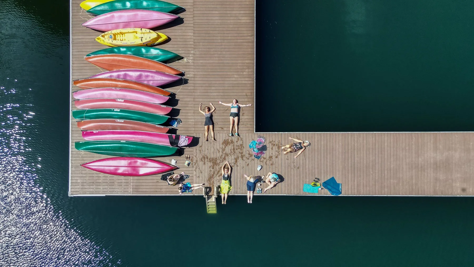 Colorful kayaks at dock during retreat, retreat activities photography Nova Scotia