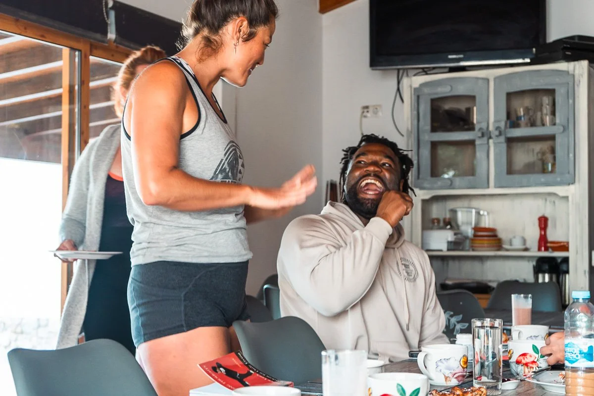 Teacher and student laughing at retreat, candid wellness retreat photography
