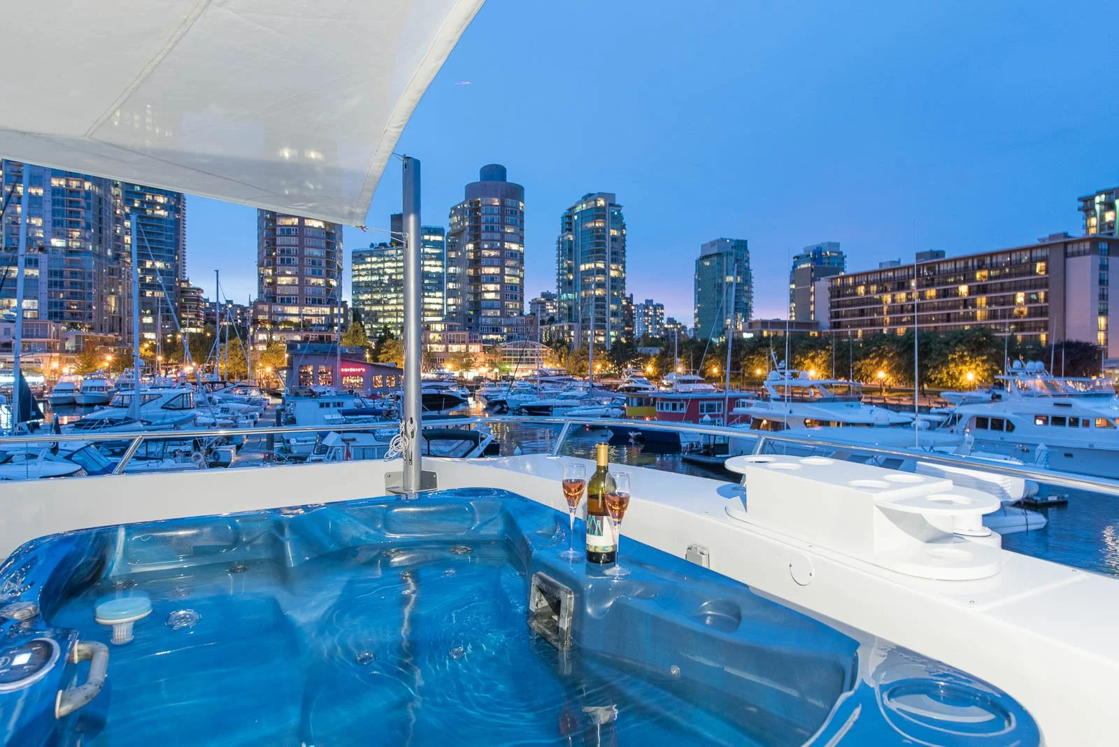 Luxury yacht hot tub with city skyline at dusk, architectural photographer Vancouver