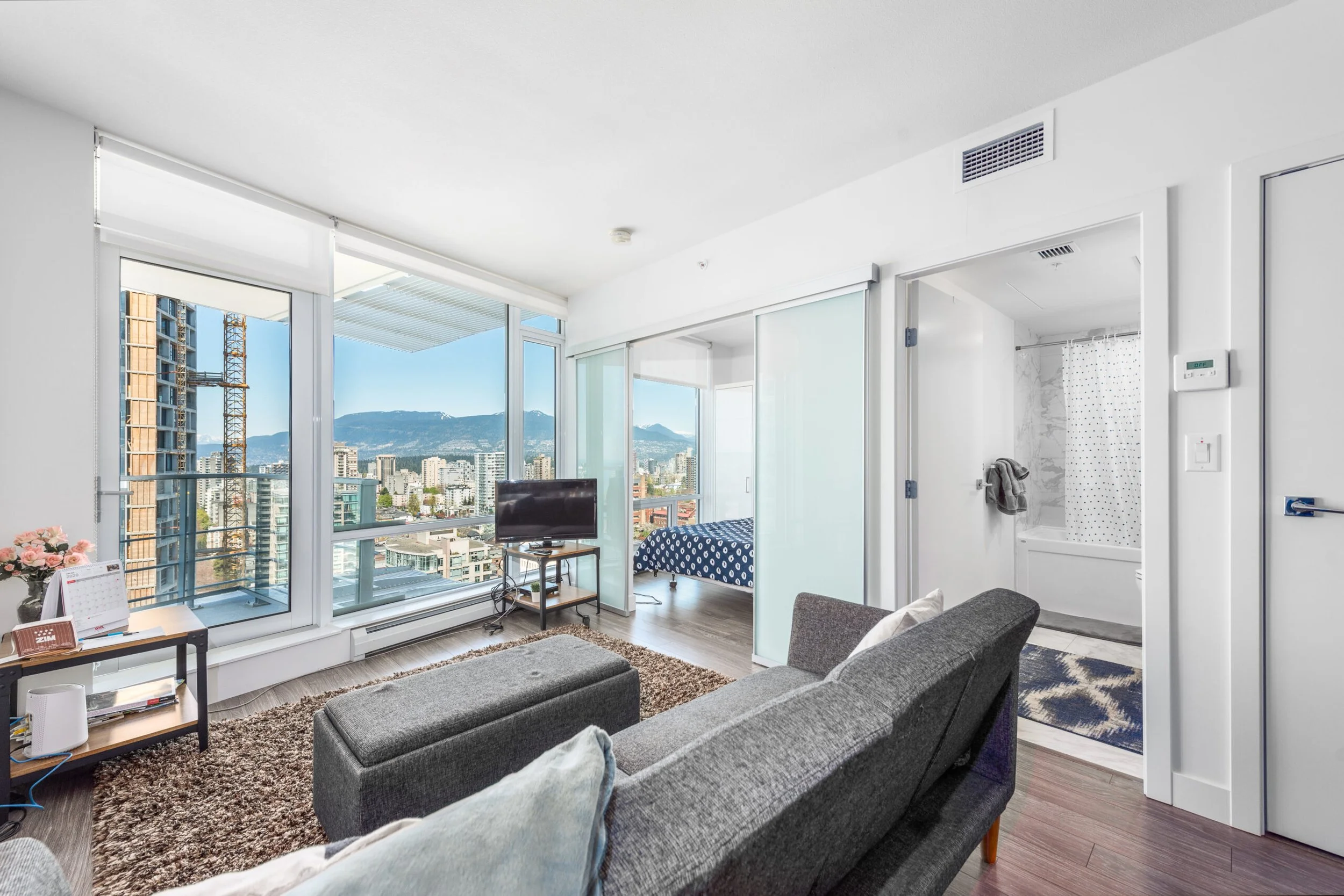 Condo living room with city views, real estate photograper Vancouver