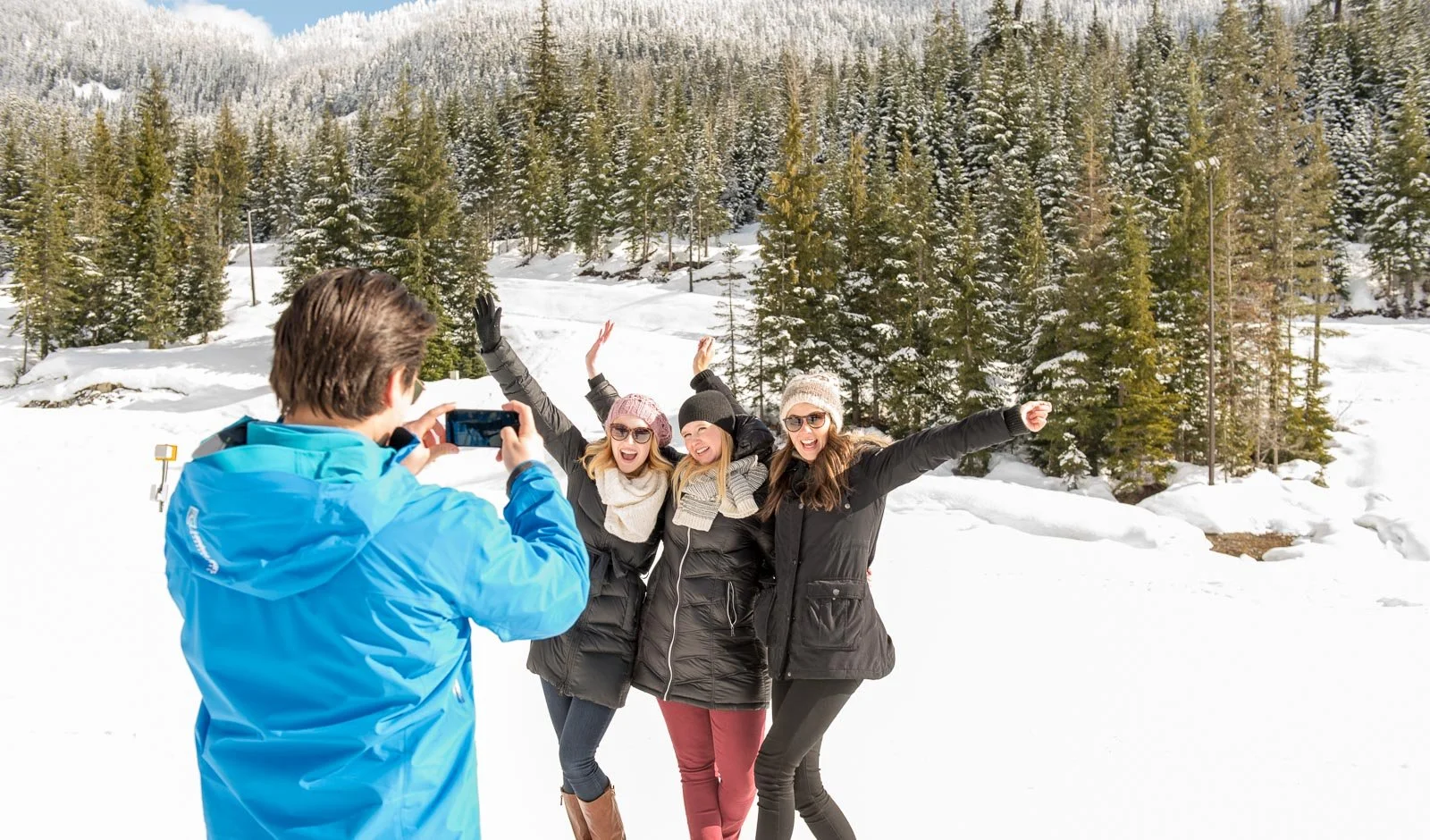 Group of friends posing for winter photo in snowy forest, Queens County branding photography