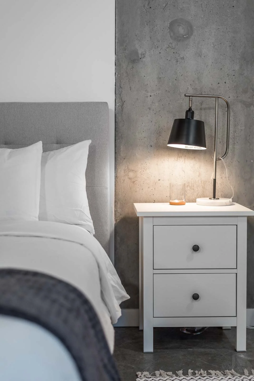 Minimalist bedroom with nightstand and lamp, Halifax architecture photographer