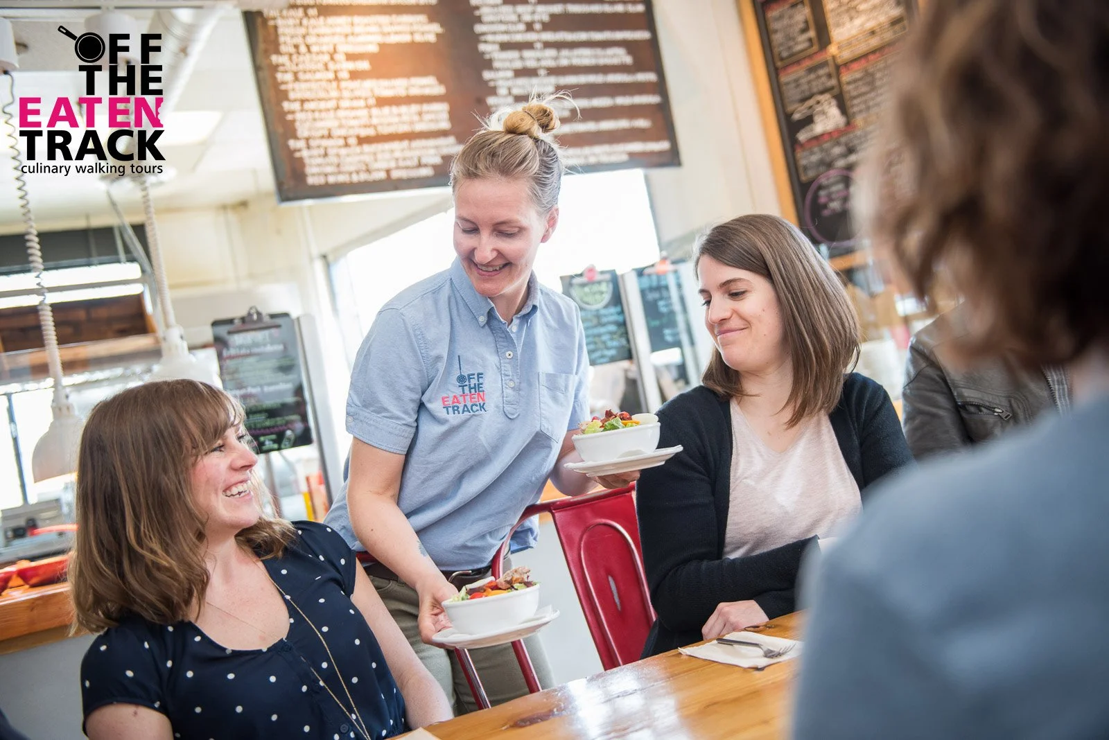 Restaurant branding photography, photo of server with customers in café