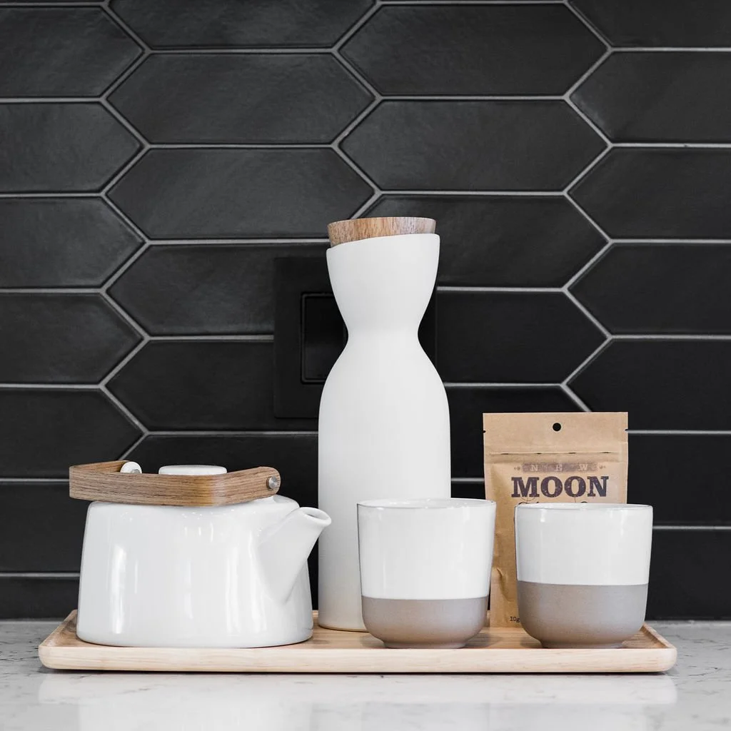 Black tile kitchen with ceramic jars, product branding photography Halifax