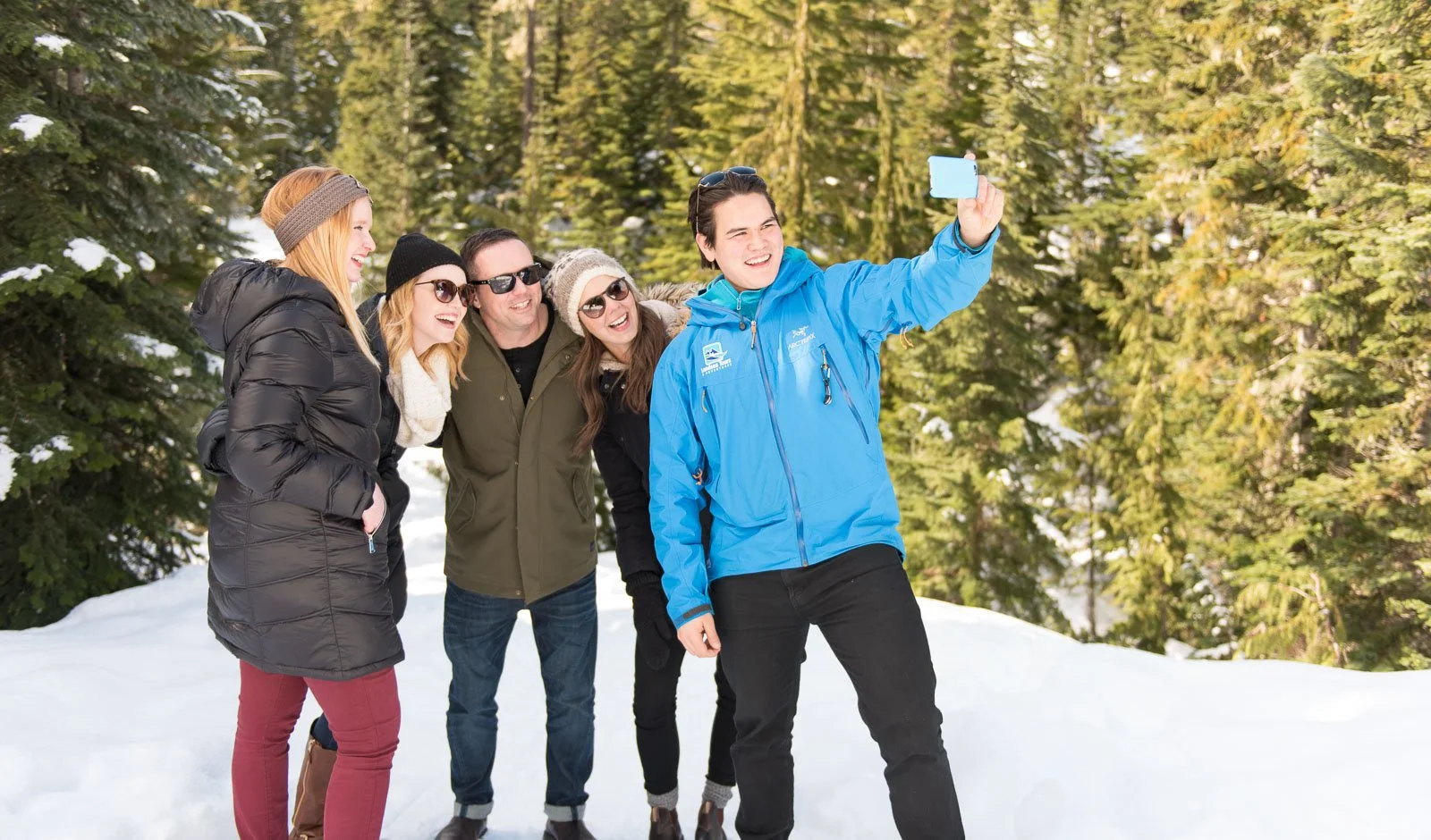 Group of friends in snow with photographer, Landsea Tours branding shoot