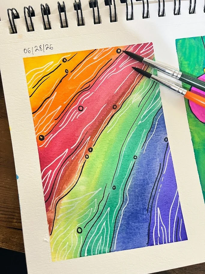Colorful abstract art resembling a rainbow with black and white lines and small circles, created with watercolors and ink pens on white textured paper.