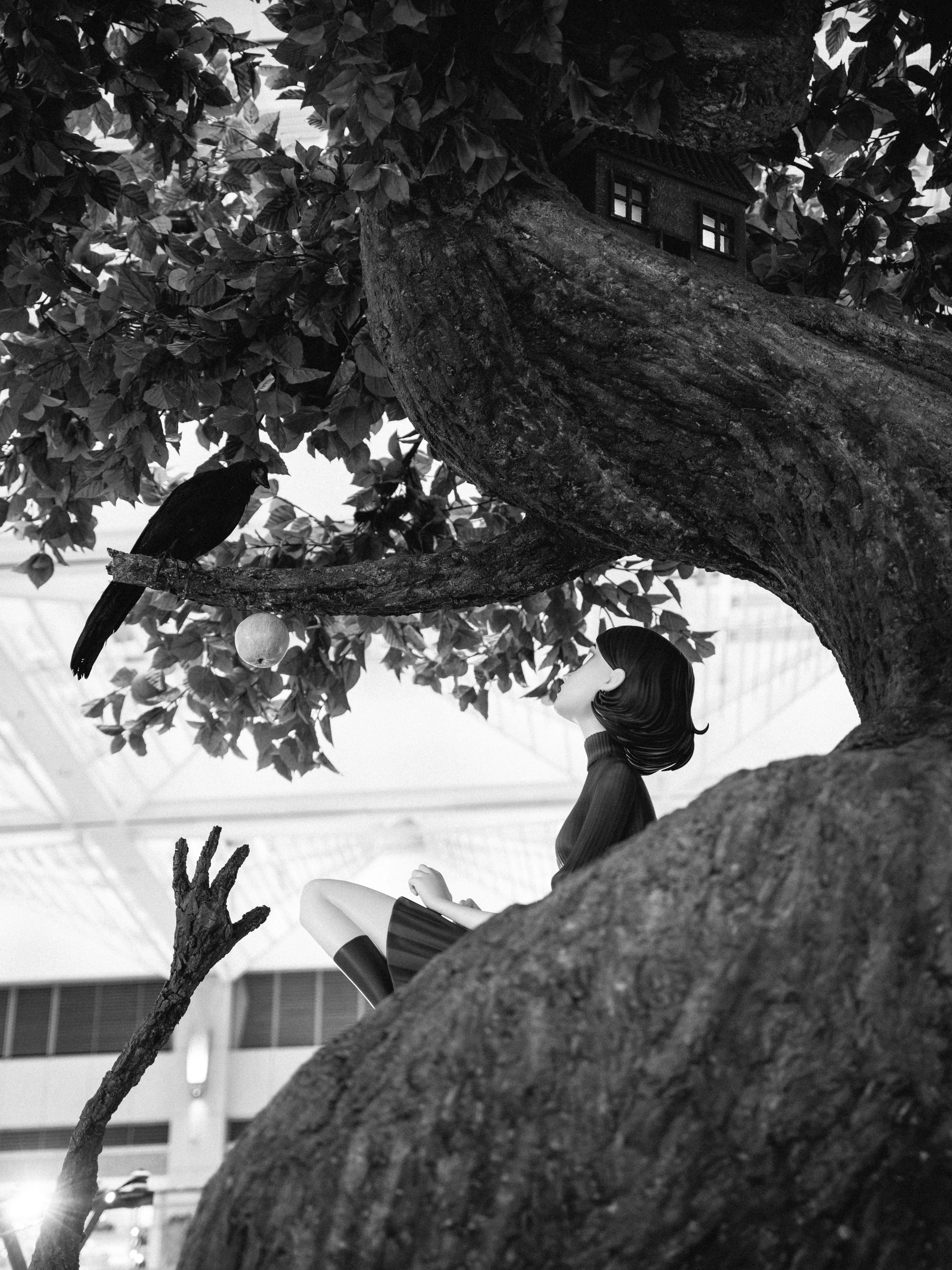 A black and white photo of a woman with short hair sitting on a large tree branch, looking up at a bird sitting on another branch of the tree. The tree has dense leaves and a small house-shaped birdhouse attached to it. The background shows the insid